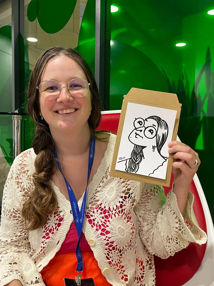Social west event guest holding up her photo looking happy with the result. 
