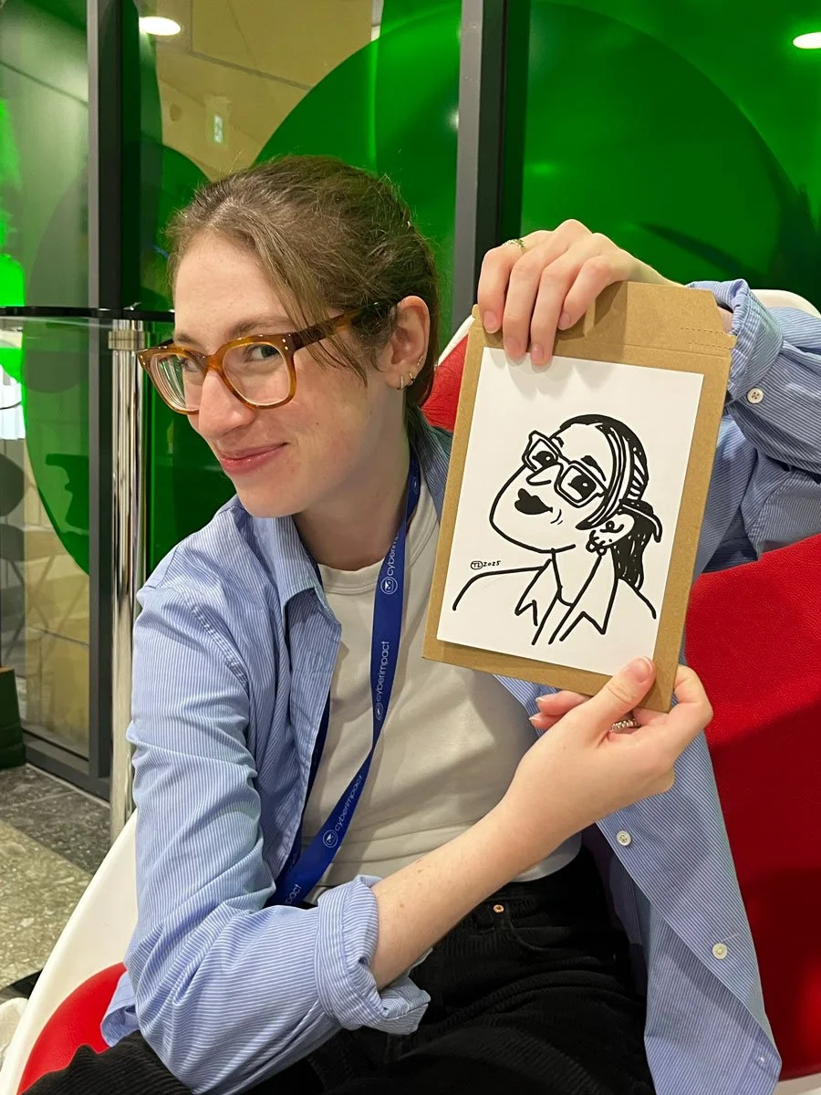 Corporate event guest holding up her derpy portrait next to her face in a unique pose with a coy facial expression 