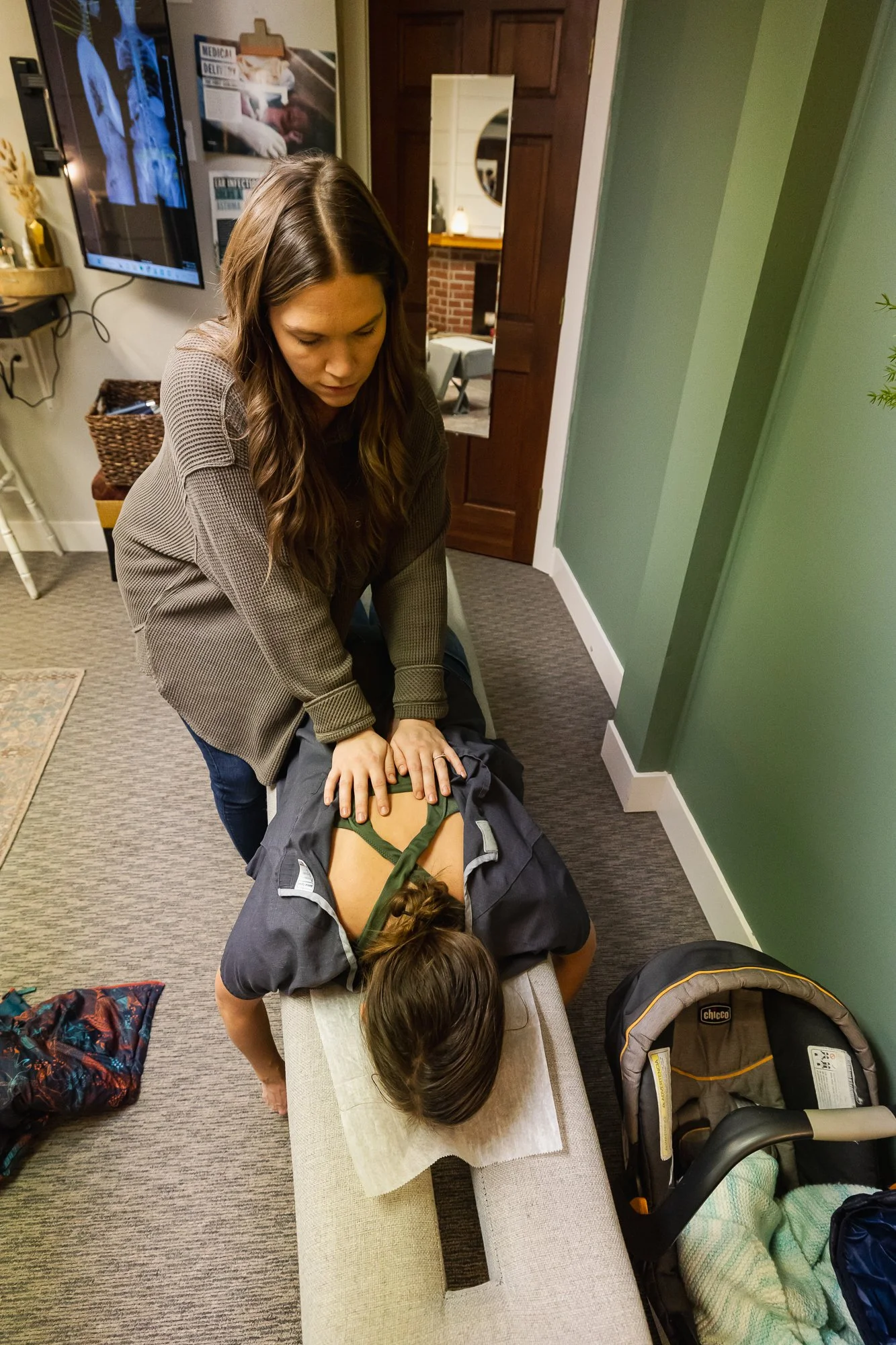 Dr. Jordan Fennelly of Two Sparrows Family Chiropractic in Whitefish, Montana adjusting a patient for her vertigo, anxiety, and migraines.