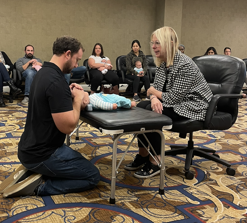 Dr. Peter of Two sparrows in whitefish, montana, is pictured getting training and ceritifications in newborn chiropractic adjustments with Claudia Anrig