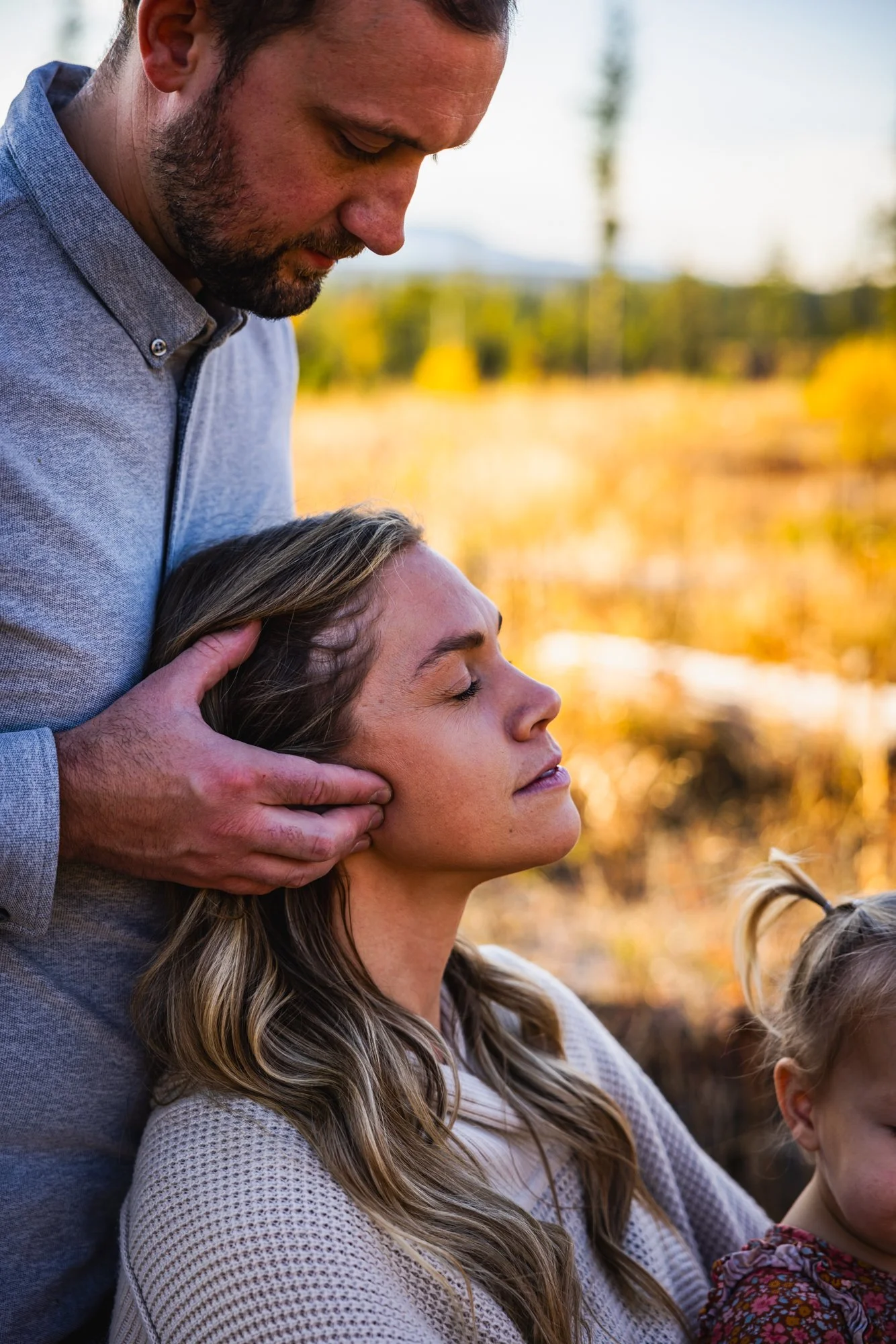 Dr. Peter Fennelly is assessing and adjusting a patient's temporomandibular joint (TMJ), for her TMJD at his practice Two Sparrows Family Chiropractic in Whitefish, Montana