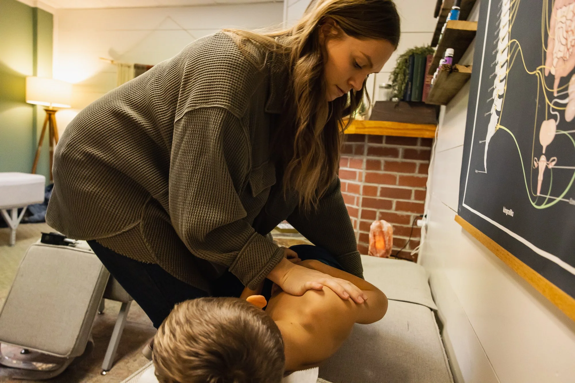 Dr. Jordan Fennelly manually adjusting a pediatric patient's low back using the Gonstead Method. 