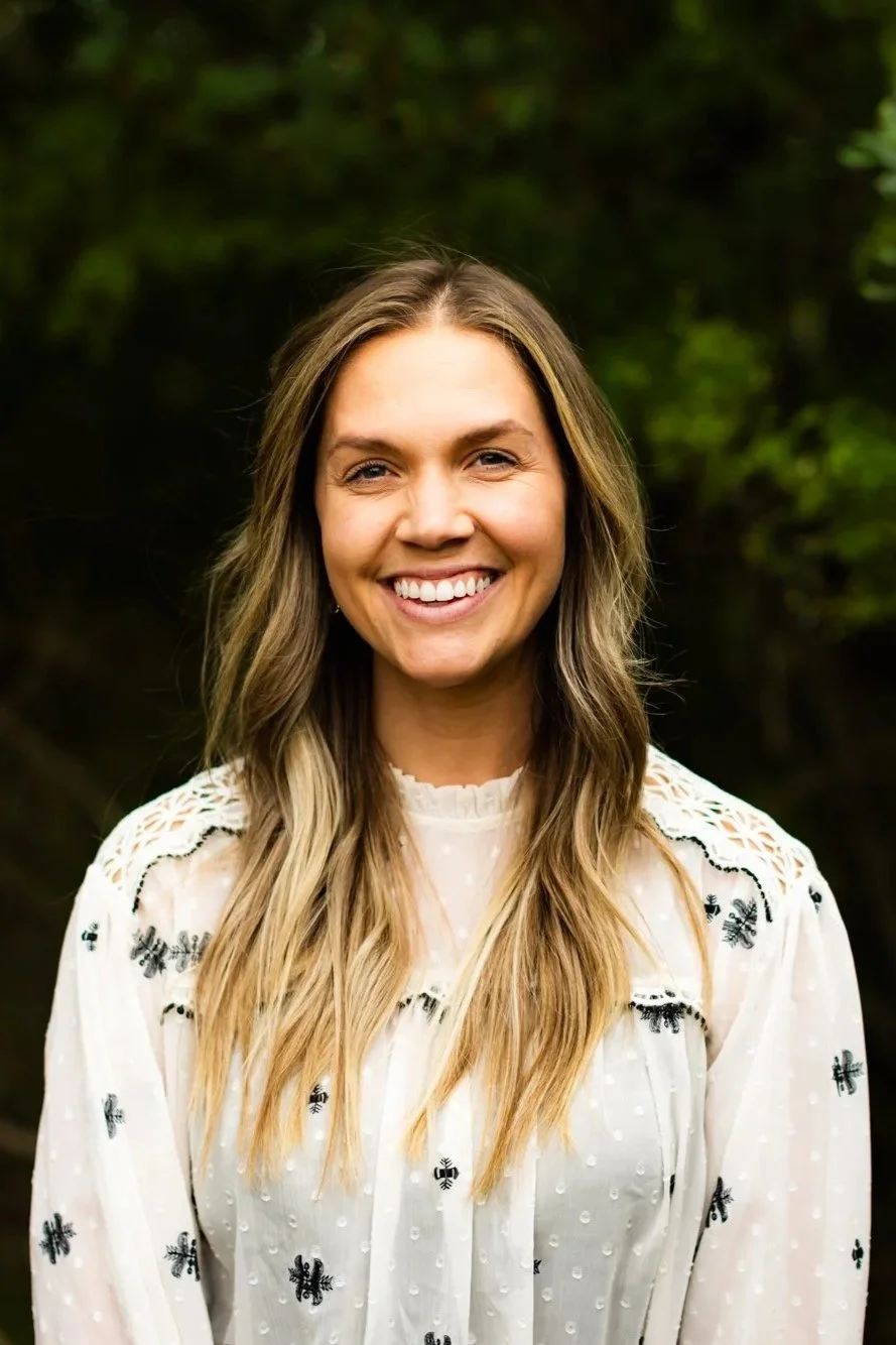 Dr. Jordan Fennelly standing by her chiropractic practice, Two Sparrows Family Chiropractic in Whitefish, Montana