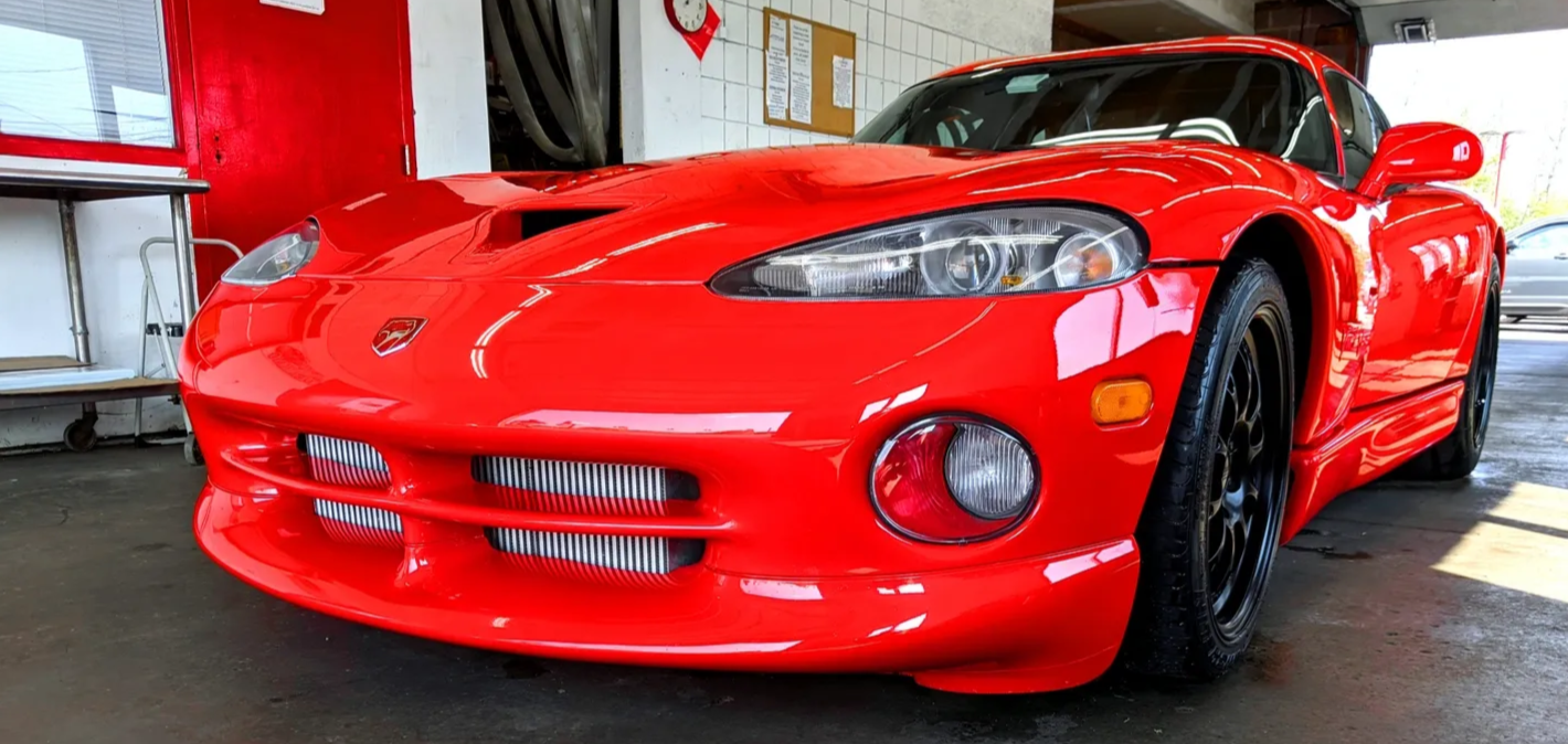 Red sports car parked inside DR. HUGGS car wash