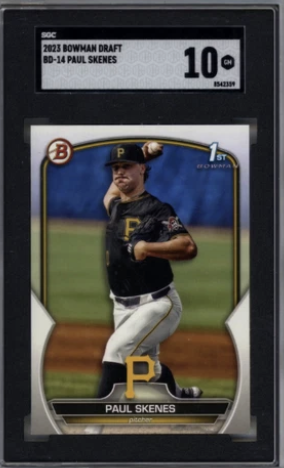 A sports trading card of Paul Skene, a baseball player for the Pittsburgh Pirates, shown in a pitching stance on a baseball field. The card has a black, gold, and white design with the Pirates logo and his name at the bottom. It is labeled as a 2023 Bowman Draft card, rated 10 GEM MINT, and is placed inside a protective plastic case with a label indicating its details.