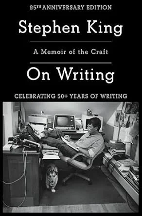 Book cover for Stephen King's memoir titled 'On Writing,' celebrating 50+ years of writing, featuring a black and white photograph of Stephen King sitting in a cluttered home office with a dog nearby, surrounded by books, computer, and writing materials.