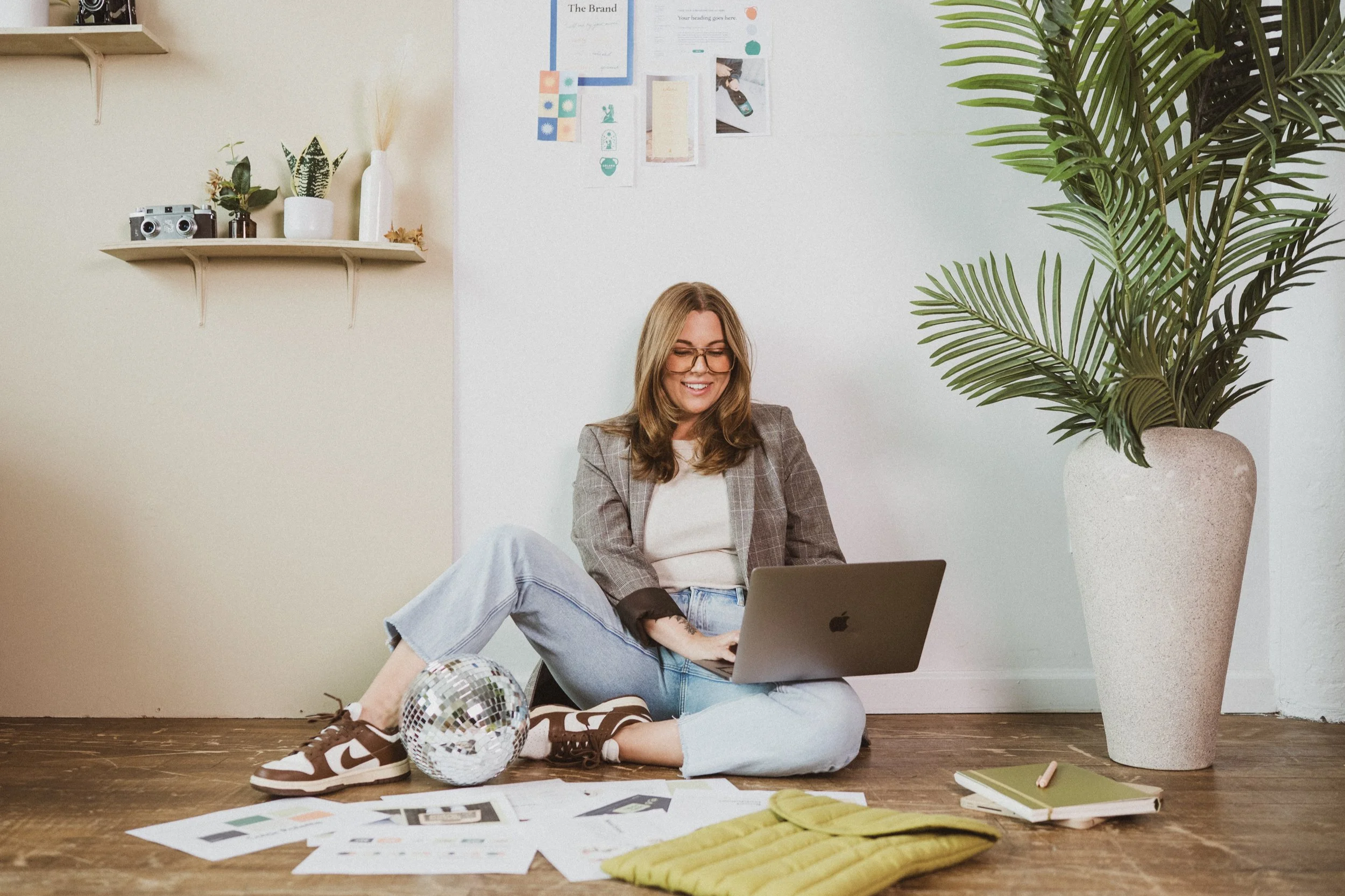 Graphic designer on laptop with disco ball