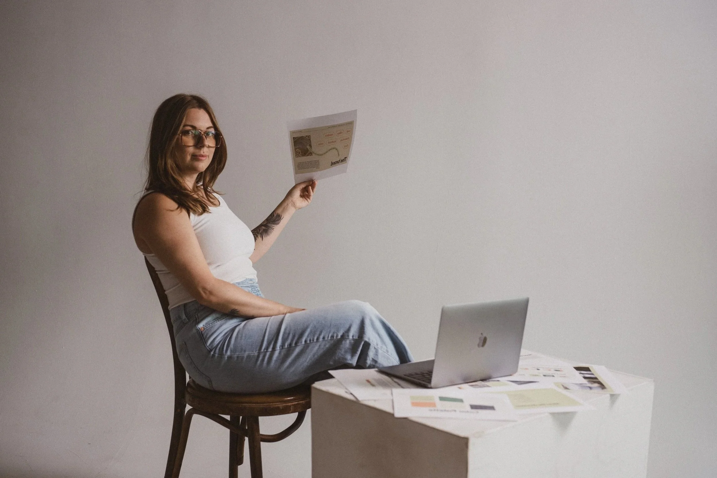 graphic designer holding a printed brand presentation