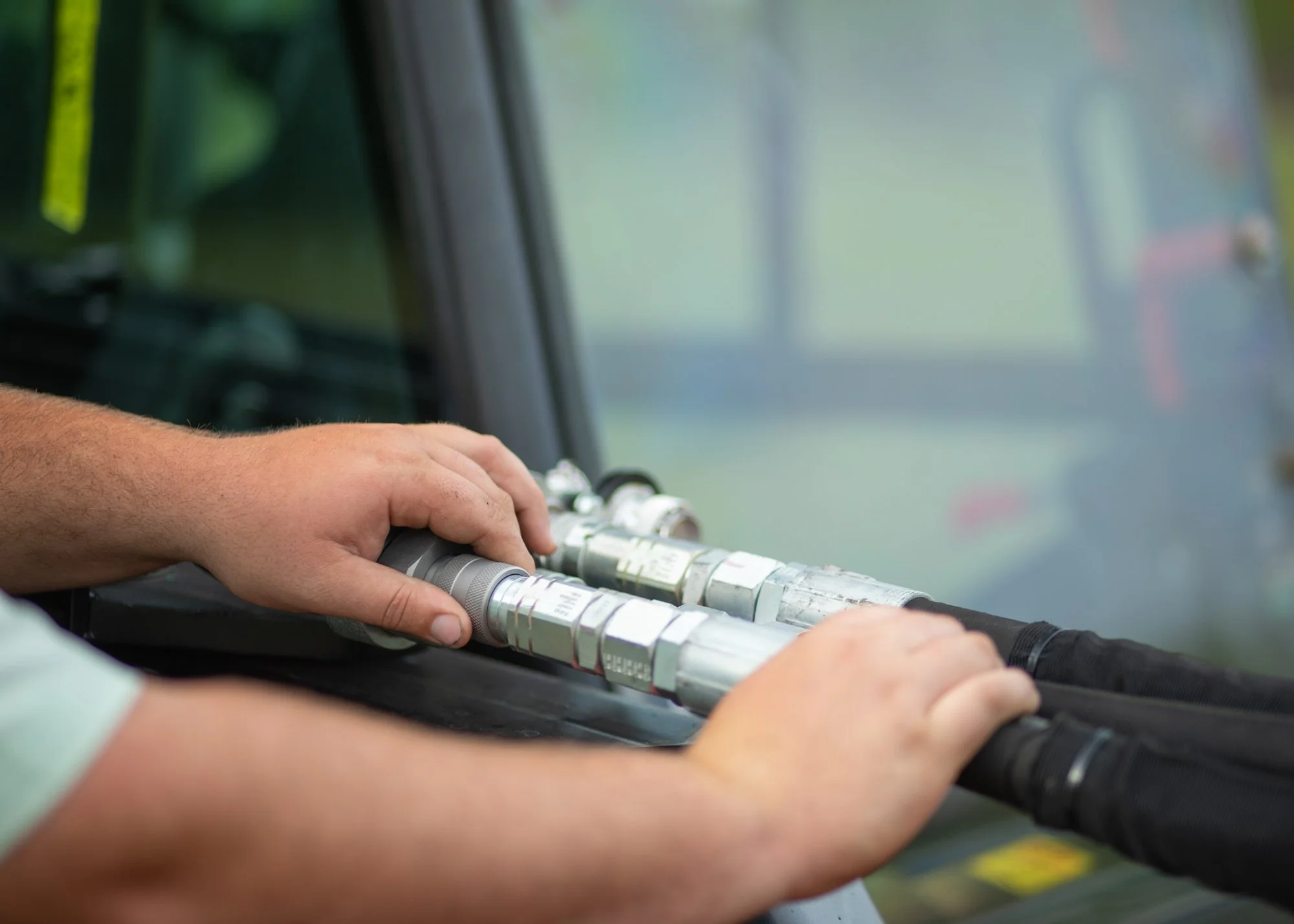 Close-up of a person's hand playing an electronic wind instrument, likely a saxophone or similar, with a blurred background.