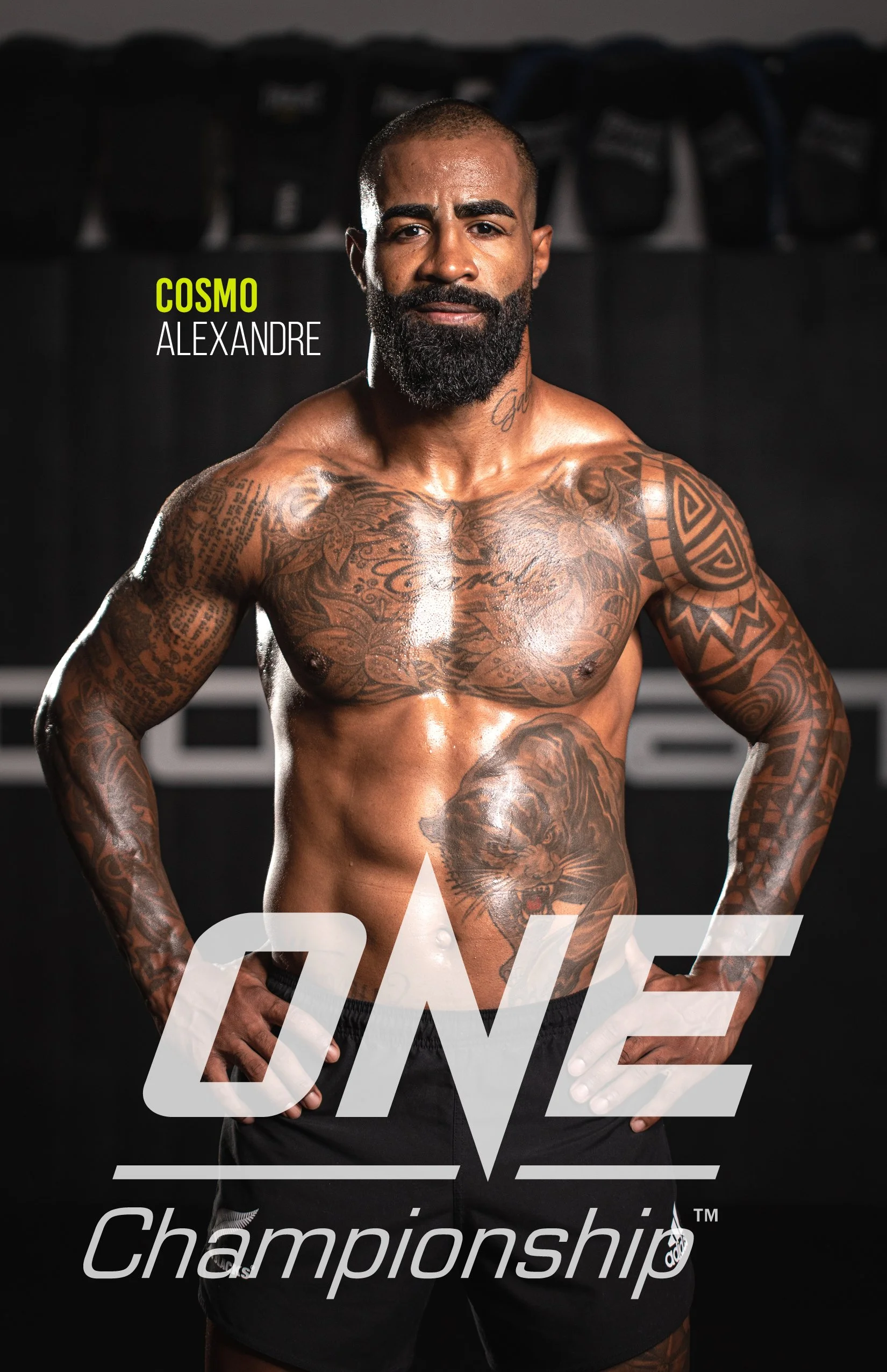 A muscular man with tattoos on his chest and arms, standing shirtless in front of a dark background. The text 'COSMO ALEXANDRE' is visible in the image, along with the words 'ONE' and 'Championship' partially overlaid.