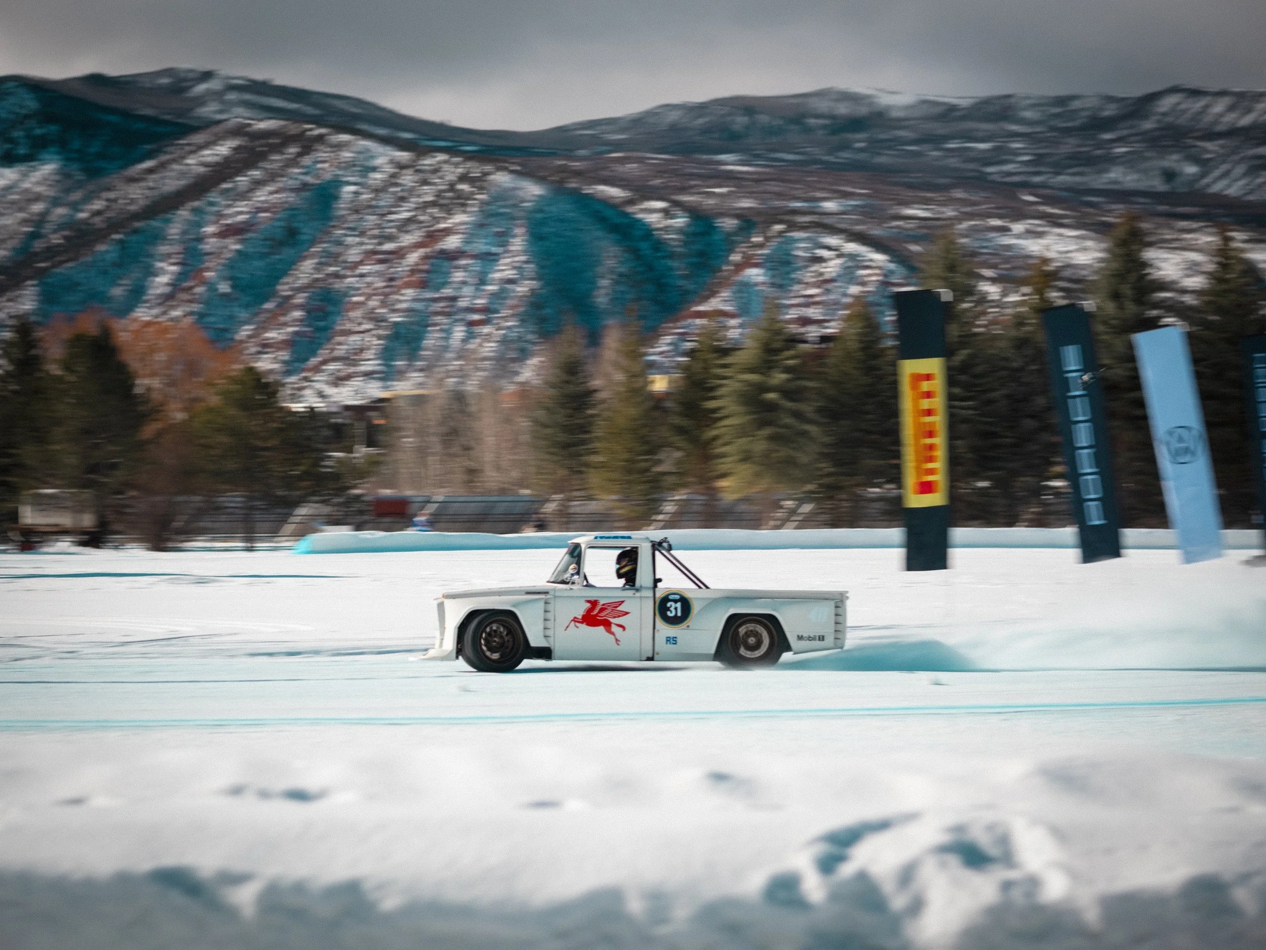 A race car with The Red Pegasus logo on the side speeding on a snow-covered track during a race. Ryan Tuerck
American racing driver