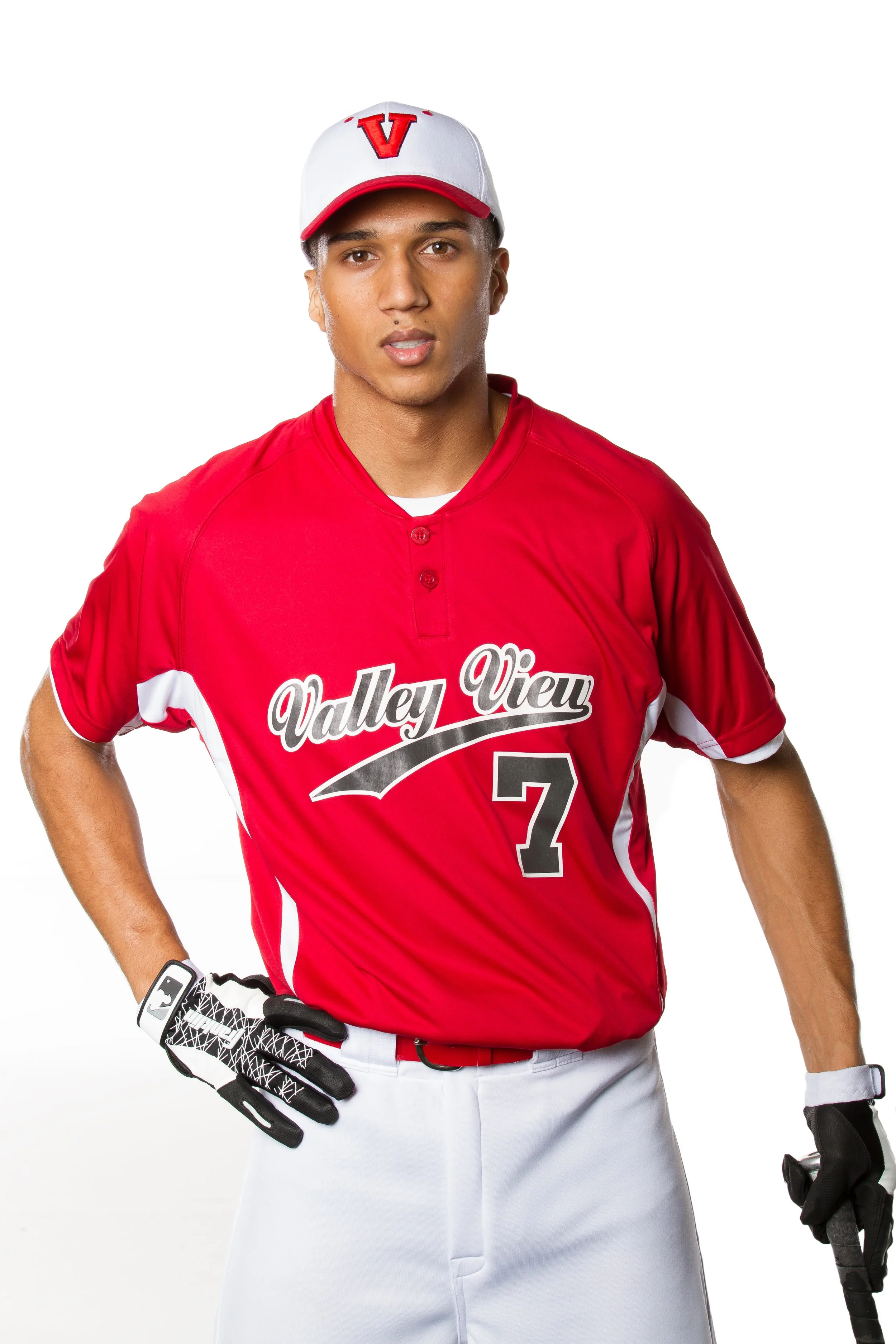 A young man dressed in a red baseball uniform with white accents, wearing a white cap with a red letter 'V,' holding a baseball glove and bat, standing against a white background.