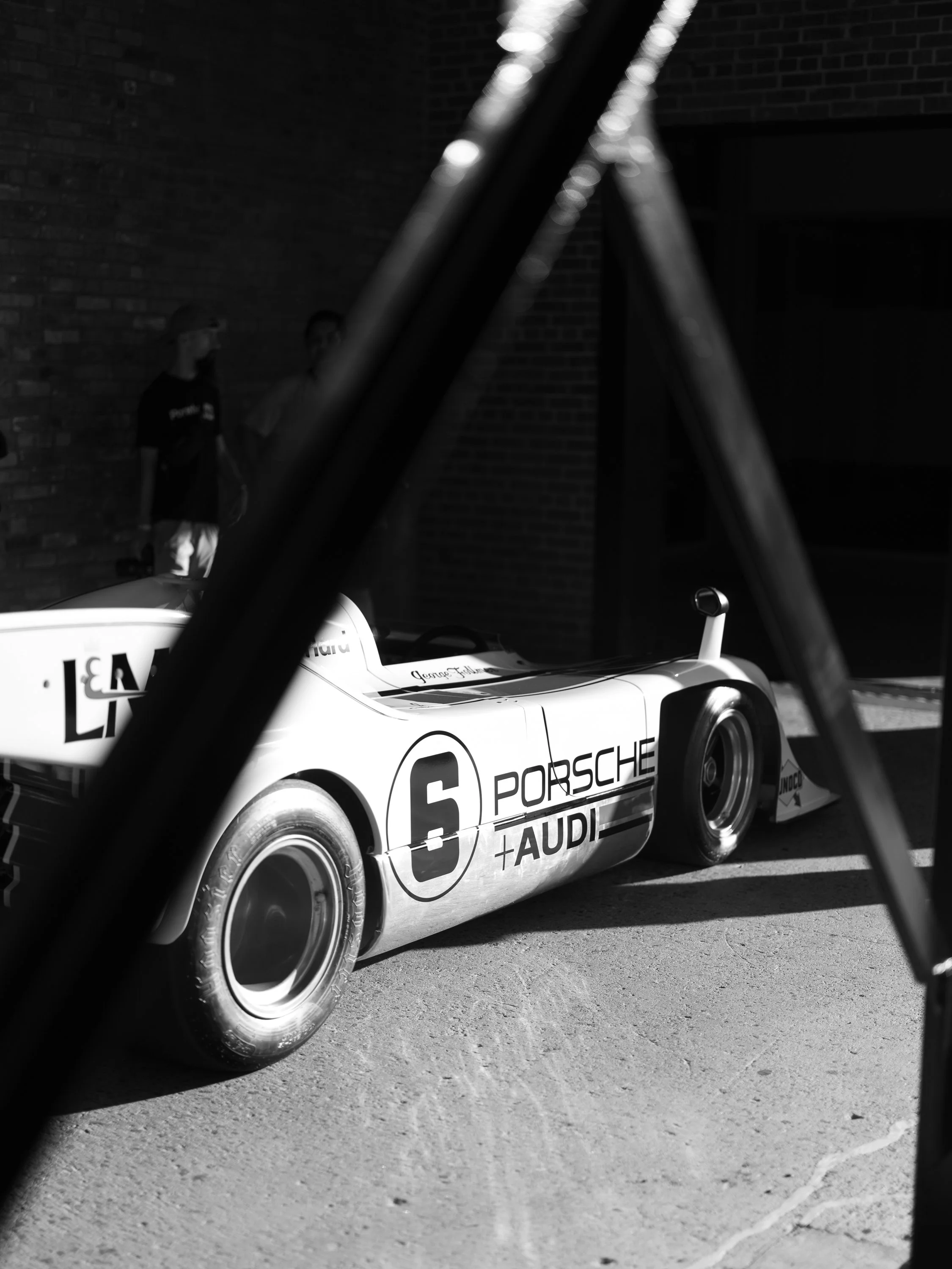Black and white photograph of a Porsche race car with 
