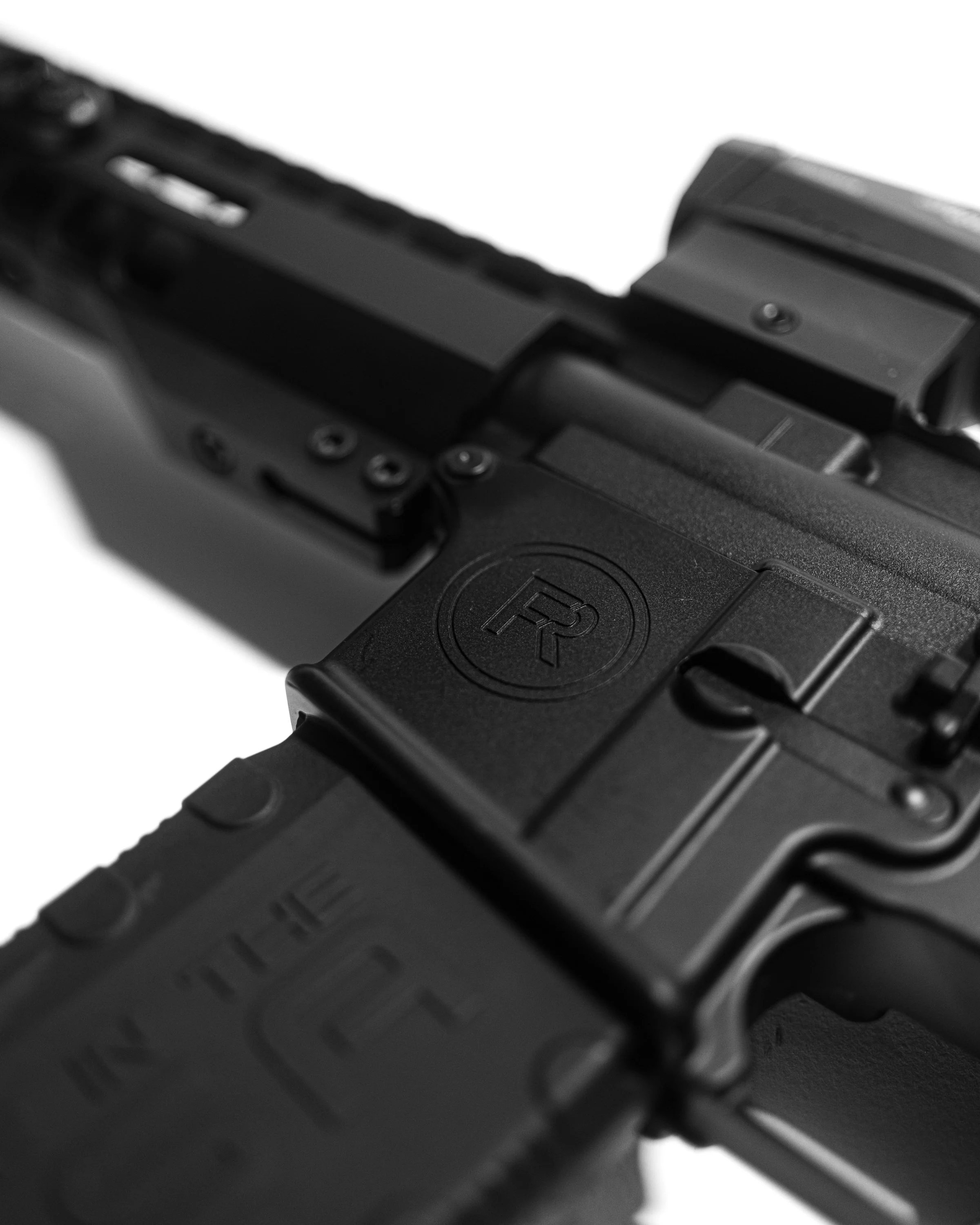 Close-up of a black semi-automatic handgun with a textured grip, slide, and trigger guard. Sig Sauer.