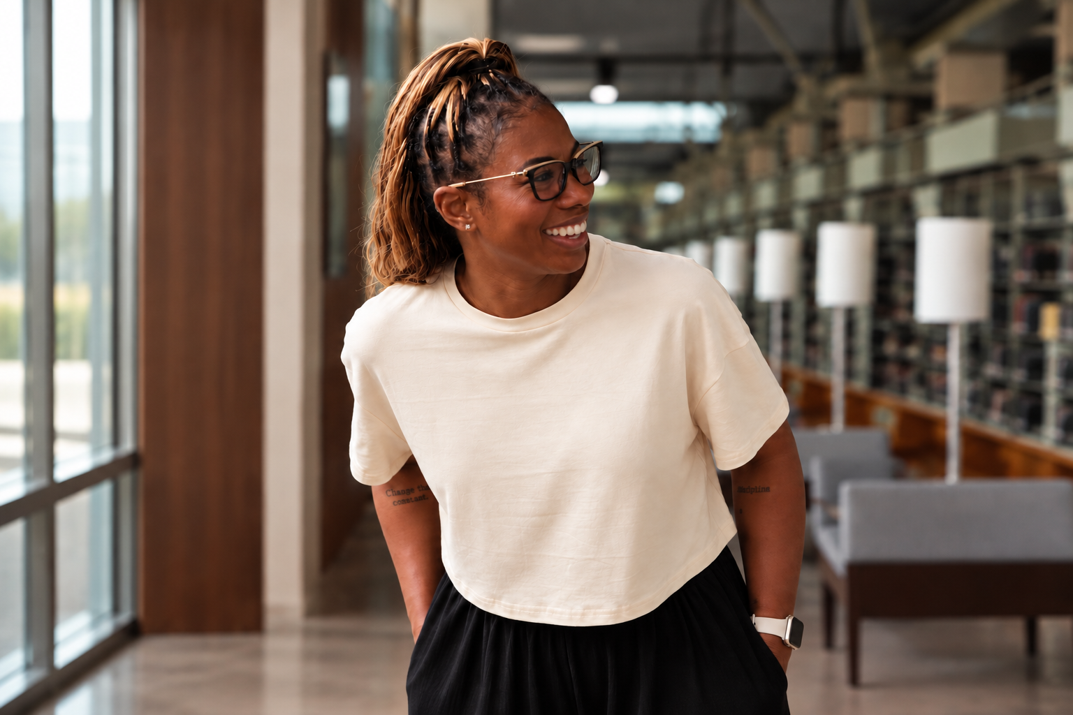 Erica Ward, MPH, LCSW-QS, smiling in a library setting.