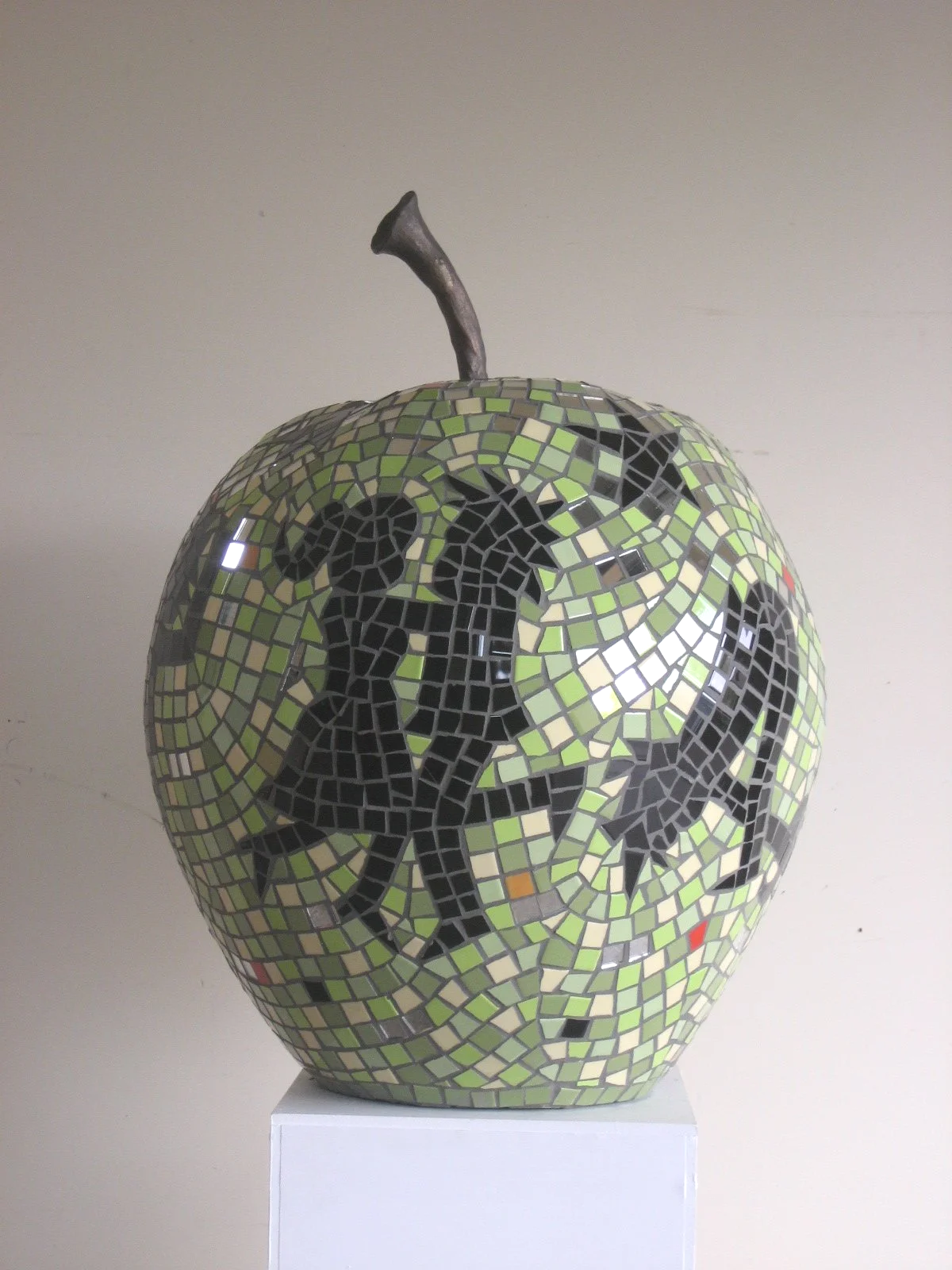 'JIVE APPLE'. (SOLD) .
The second of the 'Apple Orchard' series. 
A narrative revolves around the apple. Hand carved foam base, cement adhesive and coloured tiles, bronze stalk.