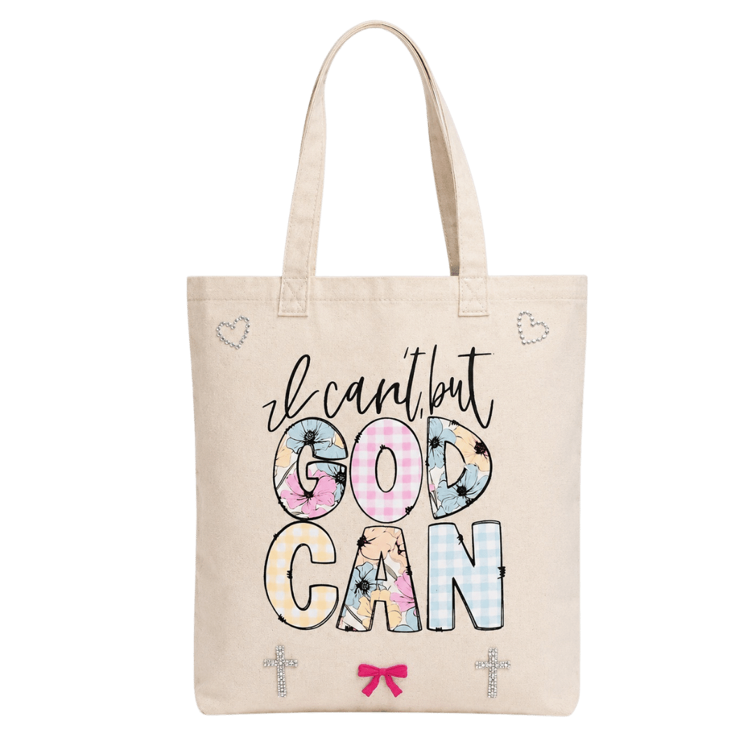 Cream canvas tote with 'I Can't But God Can' in blue and floral patchwork lettering, cross and heart rhinestone accents