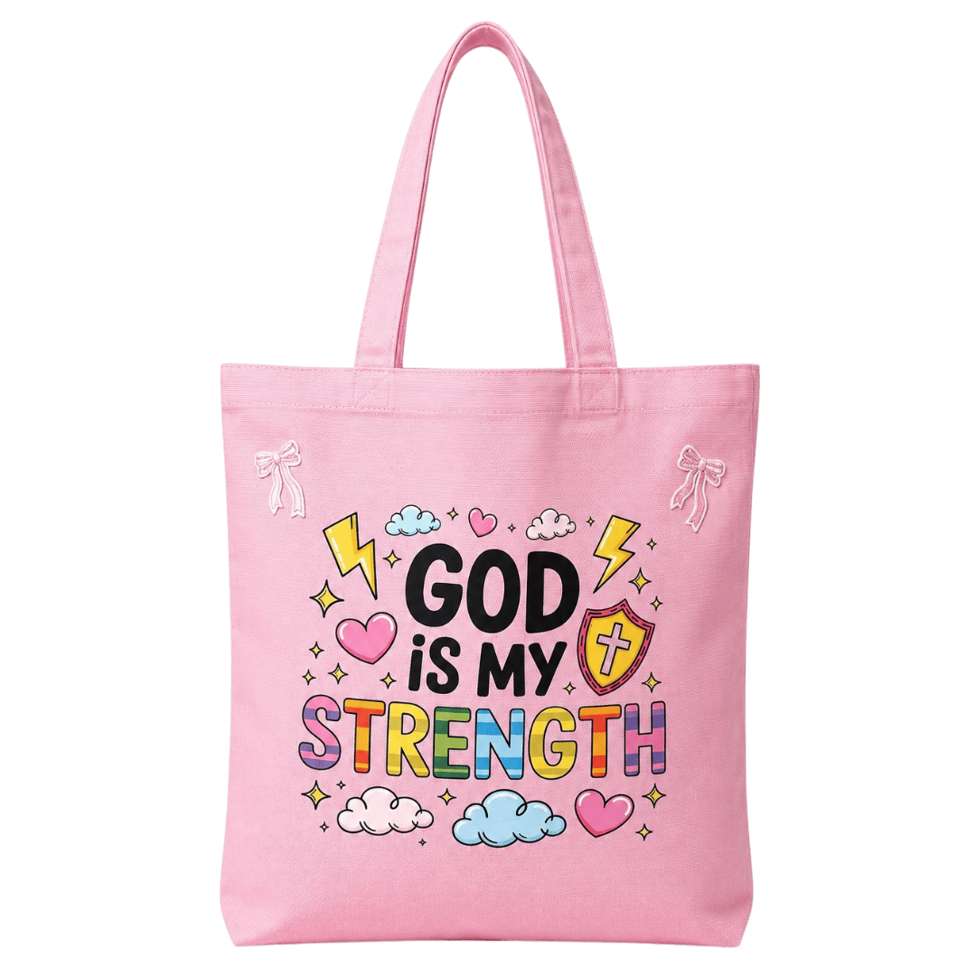 Pink canvas tote with rainbow bubble-letter 'God Is My Strength' design, lightning bolts, hearts, clouds, and a shield with cross