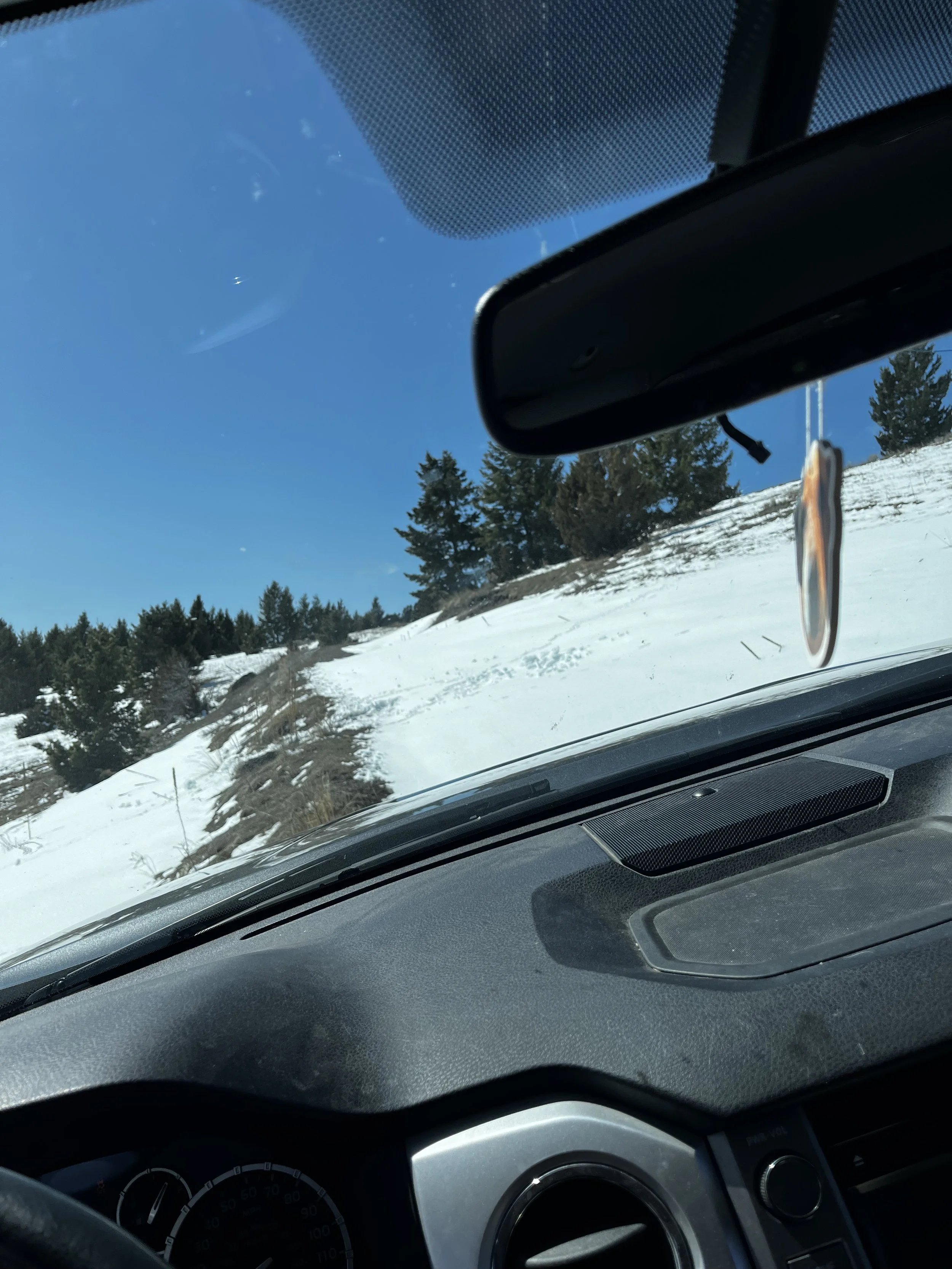 The truck 30 seconds before it almost rolled off the snow drift down the hill
