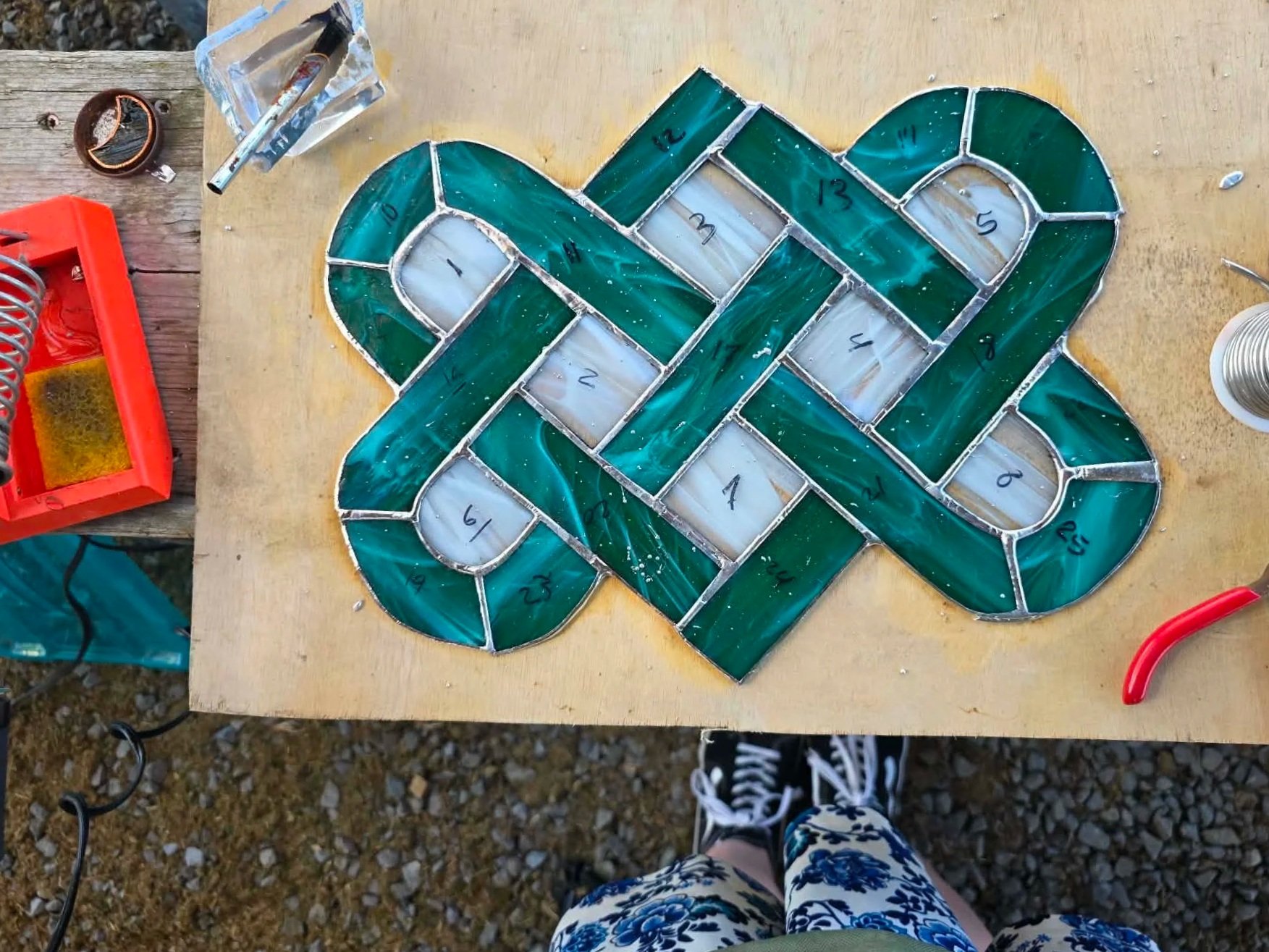 Celtic Lovers Knot in stained glass in the final stage of being soldered