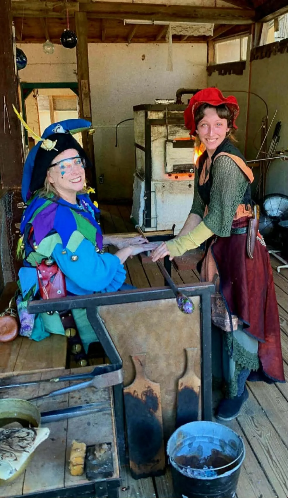 Julia Spring teaching Glass Blown class to a Renaissance Jester