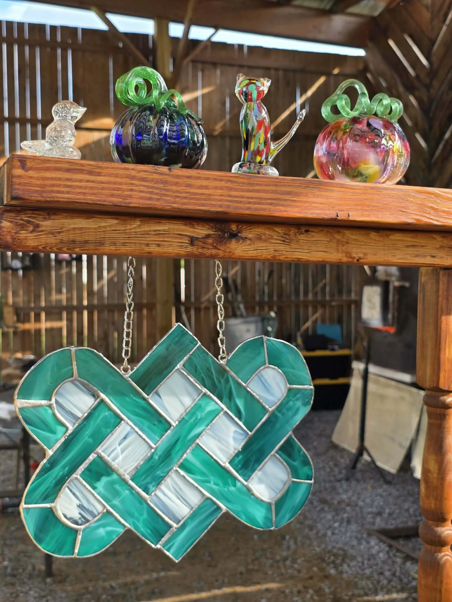 Glass Shoppe Display at the West Virginia Renaissance Festival with blown glass pumpkin's, a bird, a cat and the Celtic lovers knot
