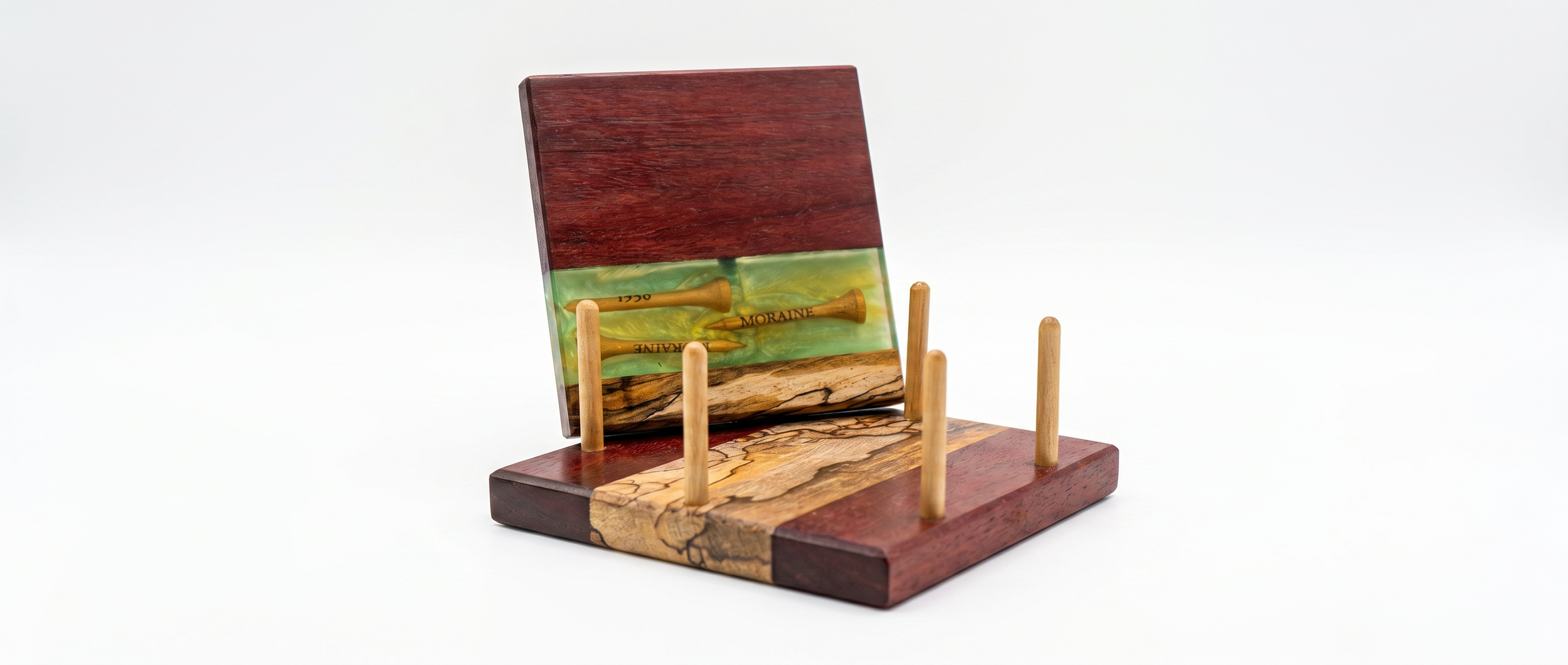 Decorative chess piece stand with colorful wood and green resin, holding small yellow golf tees on a white background.