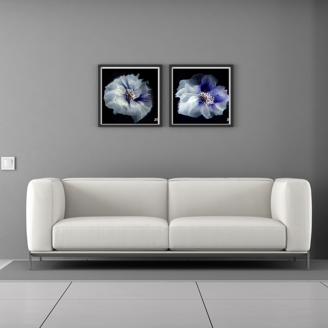 White sofa against a gray wall with two framed abstract floral fine art prints displayed above it.