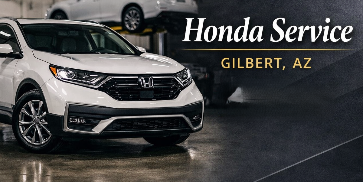A white Honda SUV parked in a garage with a banner on the right side advertising Honda Service in Gilbert, Arizona.