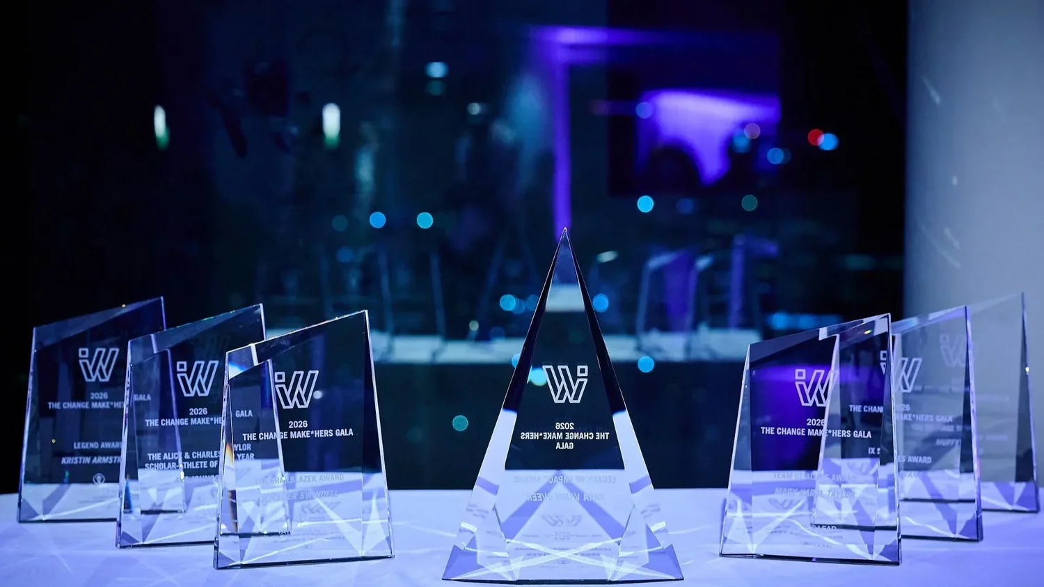 A display of the glass engraved honoree awards for the 2026 Change Make*Hers Gala