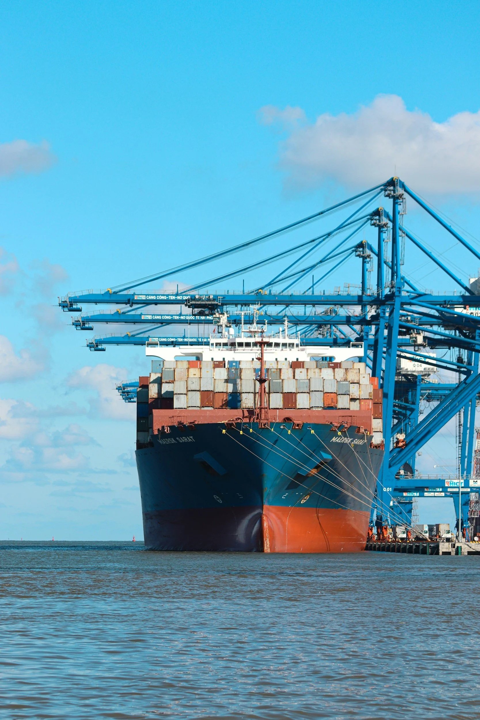 Cargo ship and shipping containers at a seaport