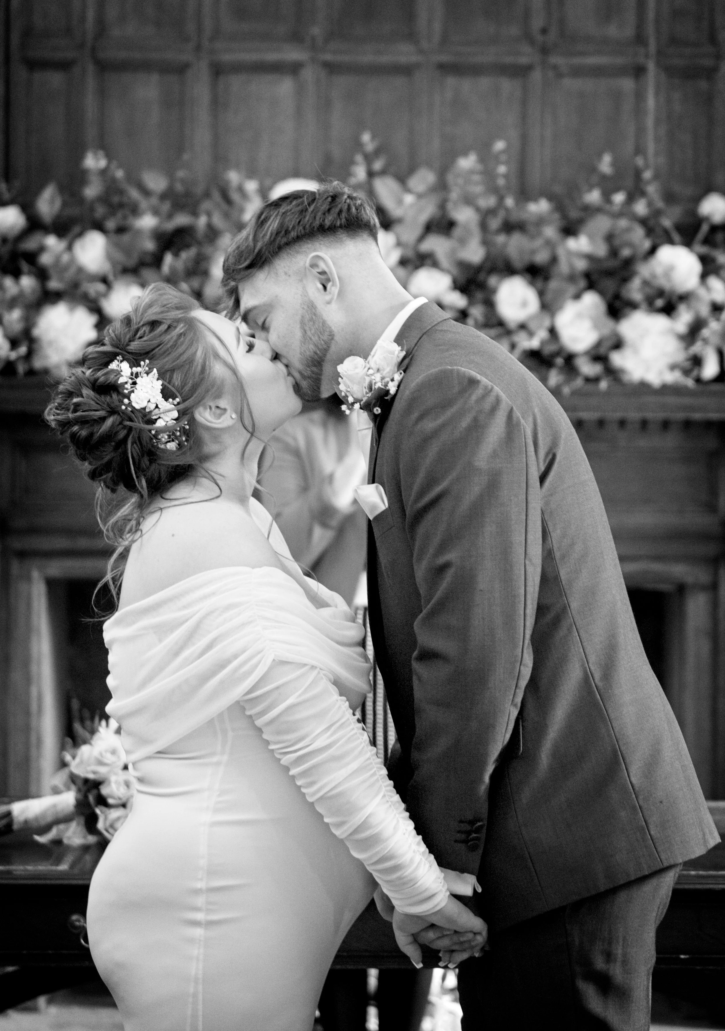 Candid wedding photography capturing the bride and groom’s first kiss at registry rooms in Cherwell.