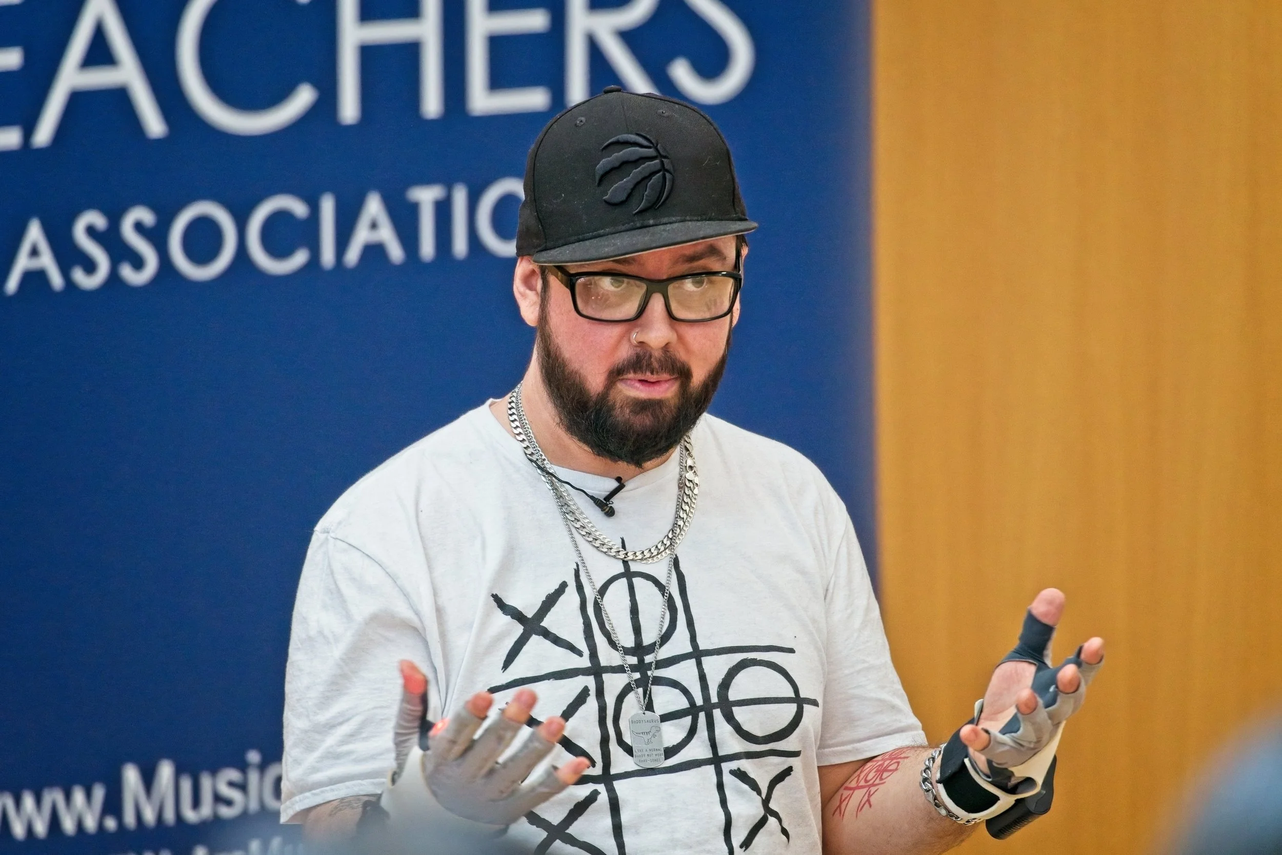 Professional corporate event photography at a school music conference. High-quality images capturing keynote speakers and networking.