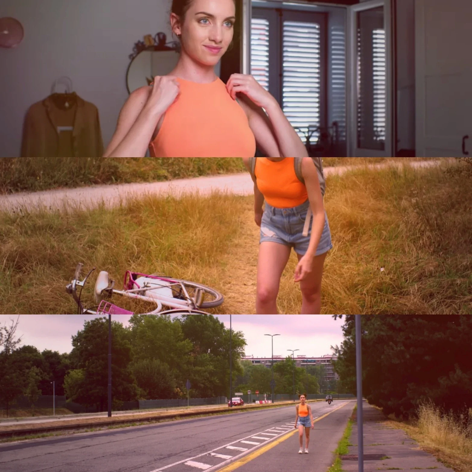Una ragazza con tank top arancione e shorts in piedi sul bordo di una strada, vicino a un'auto scassata di una bicicletta rosa, circondata da natura e alberi.