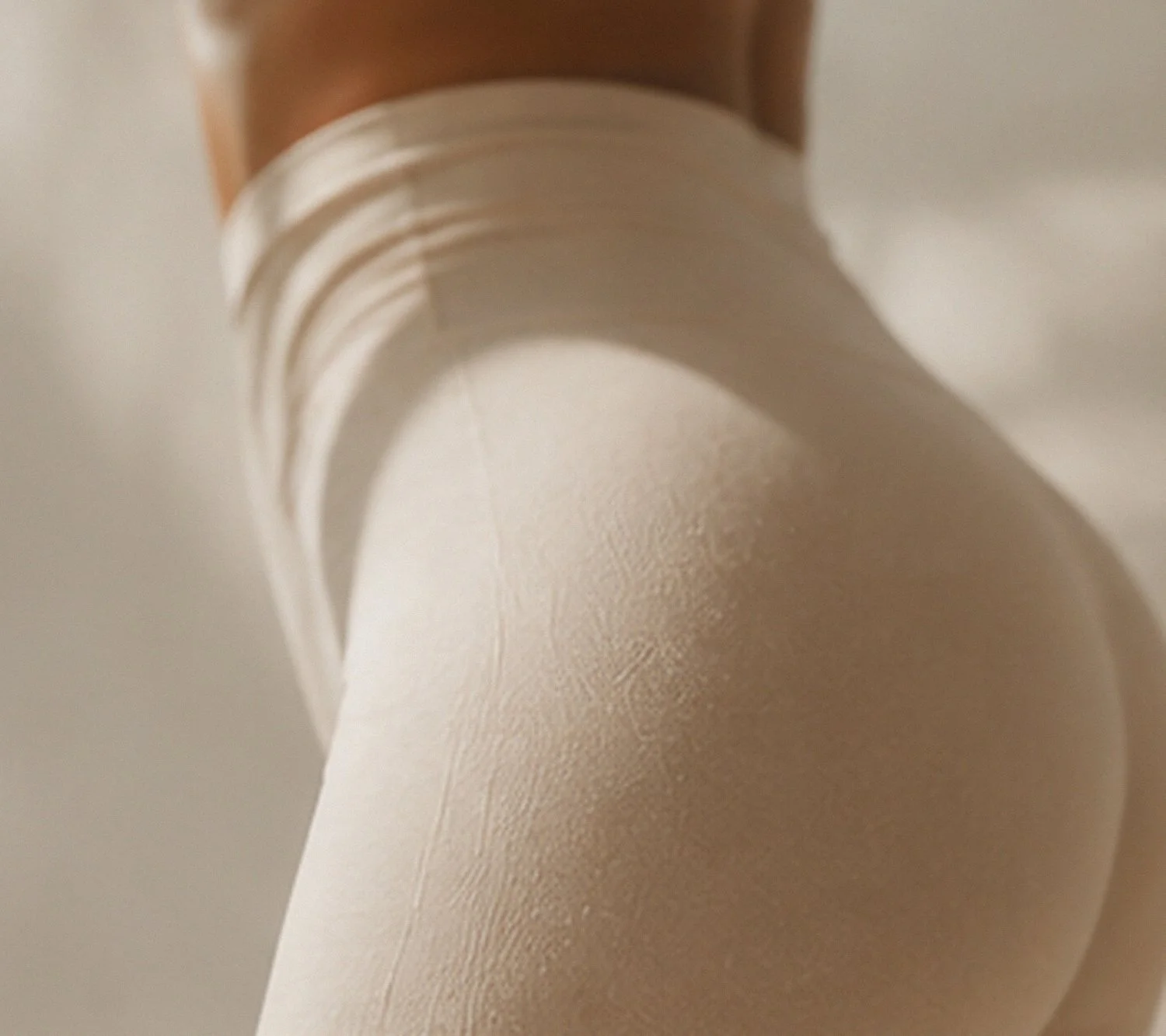Close-up of a white paper roll, partially unspooled, with a smooth texture.