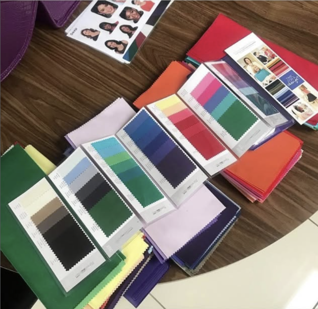 Color swatch books and sample color sheets on a table.