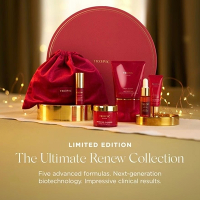 Tropic skincare gift set with red packaging, including creams, serums, and lotions, displayed on a table with decorative gold accents and text about a limited edition renewal collection.