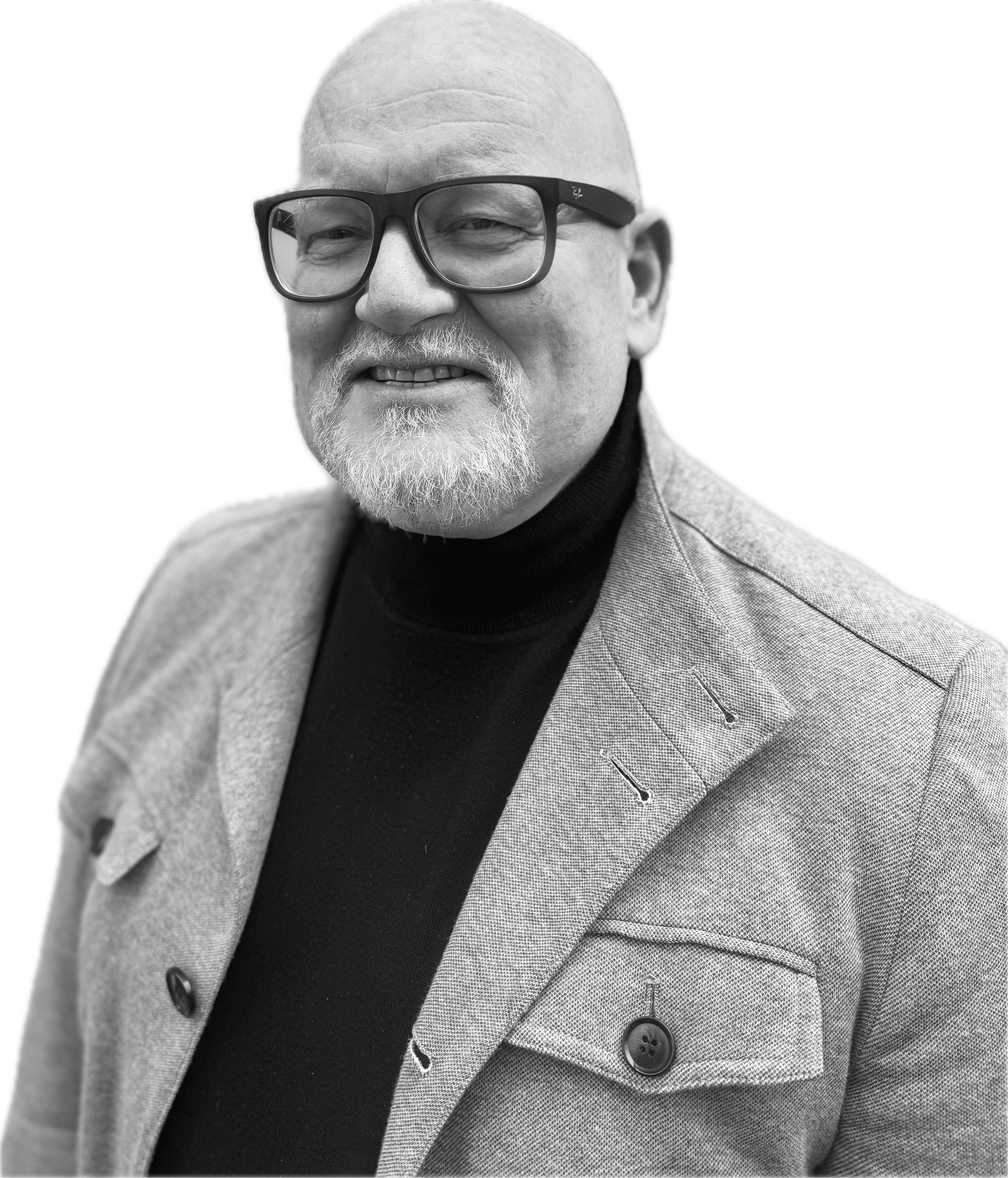 Schwarz-Weiß-Foto eines Mannes mit Glatze, Brille, weißem Schnurrbart und grauem Anzug, lächelnd.