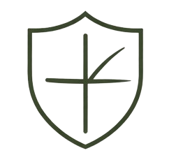 A black and white emblem featuring a shield with a stylized cross and a gauge or compass design inside.