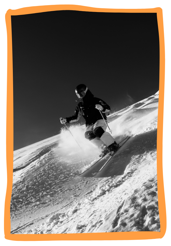 A skier is skiing downhill on snow-covered slopes.