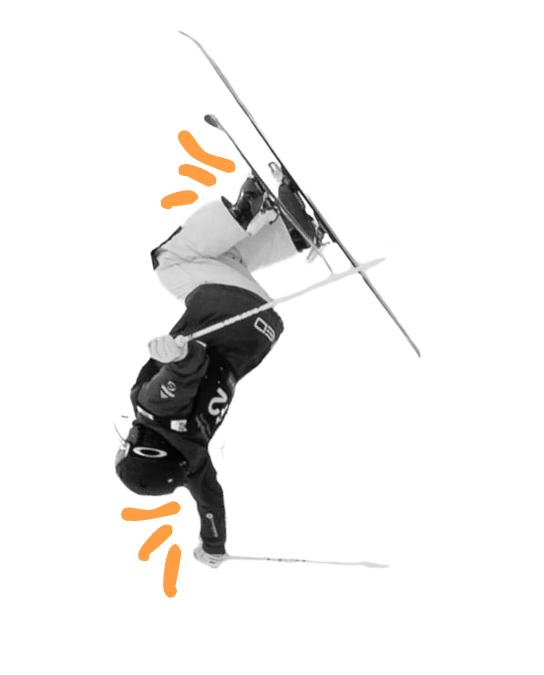A skier performing an inverted trick in mid-air, holding a ski pole with skis parallel to the ground.