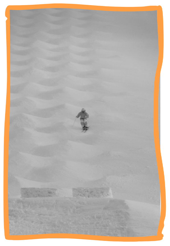 A skier descending a snowy slope with evenly spaced moguls, wearing a helmet, goggles, and winter gear.