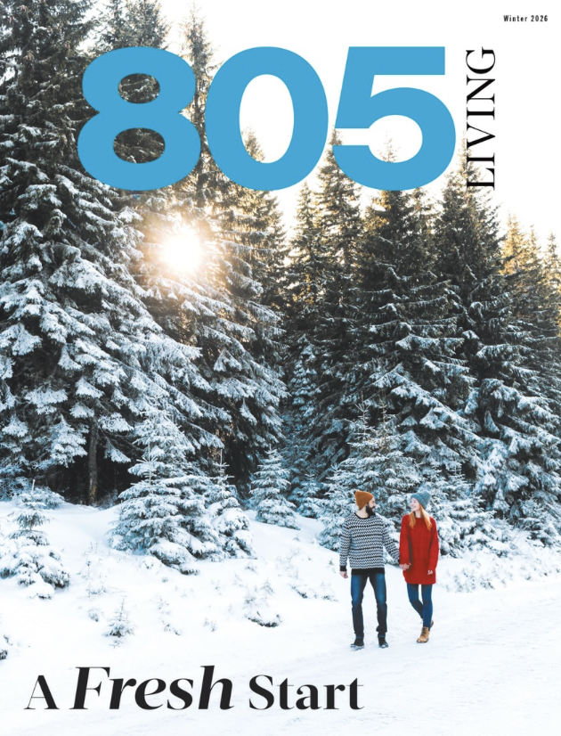 A winter landscape with snow-covered evergreen trees and two people walking hand in hand. The sun is shining through the trees. The cover title reads '805 Living' with the subtitle 'A Fresh Start'.