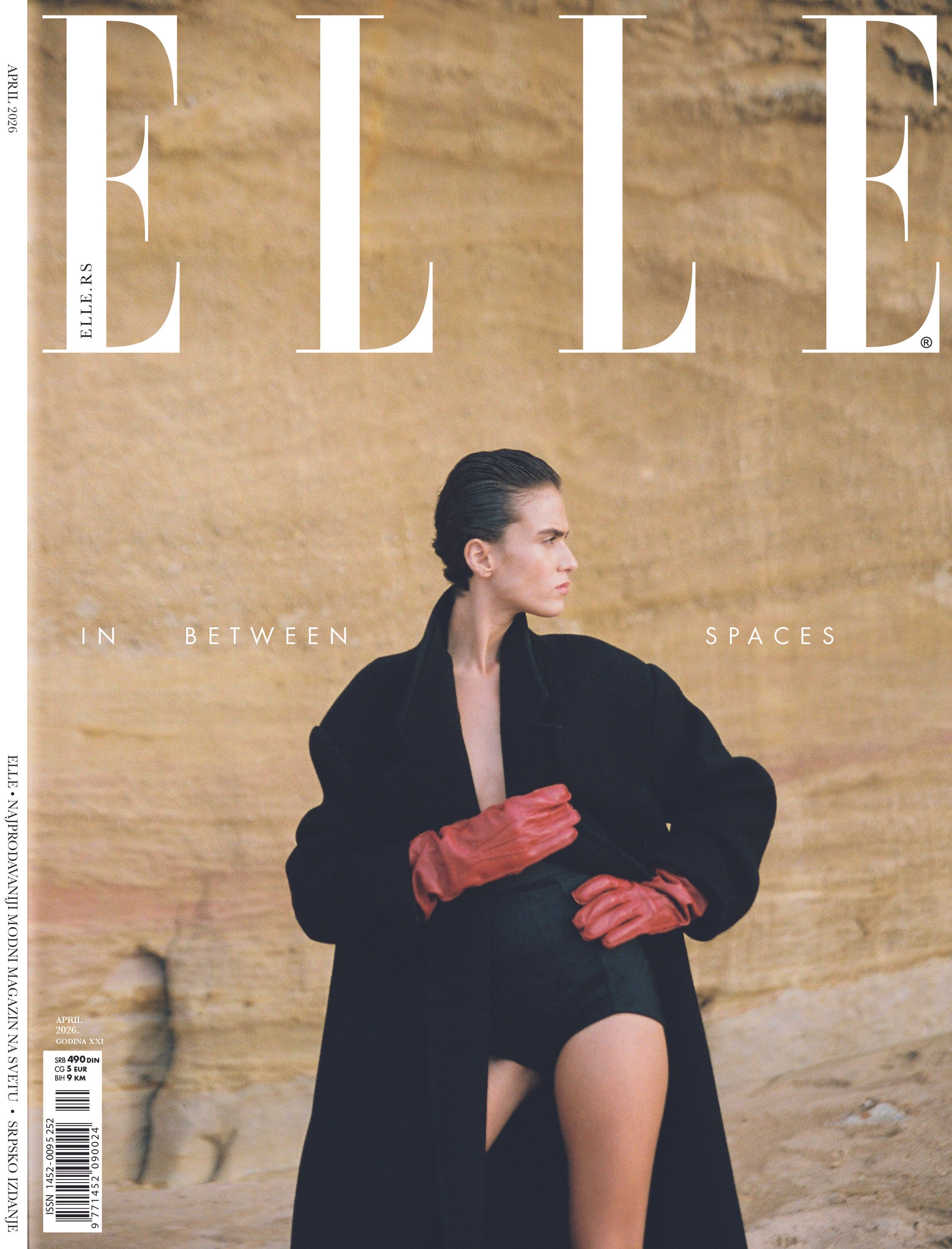 model wearing black coat for elle servia cover