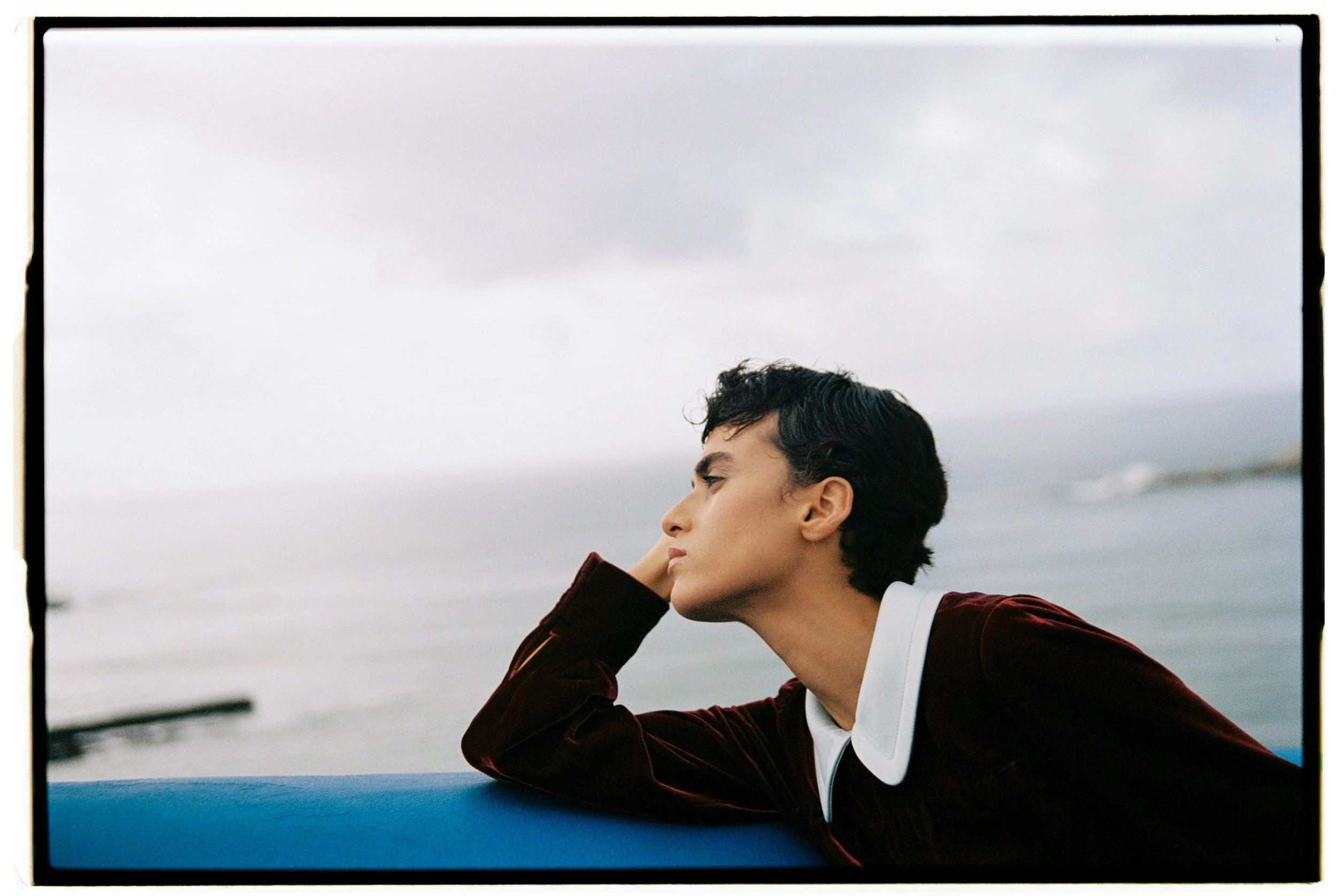 Model wearing a prada shirt by the ocean in lisbon