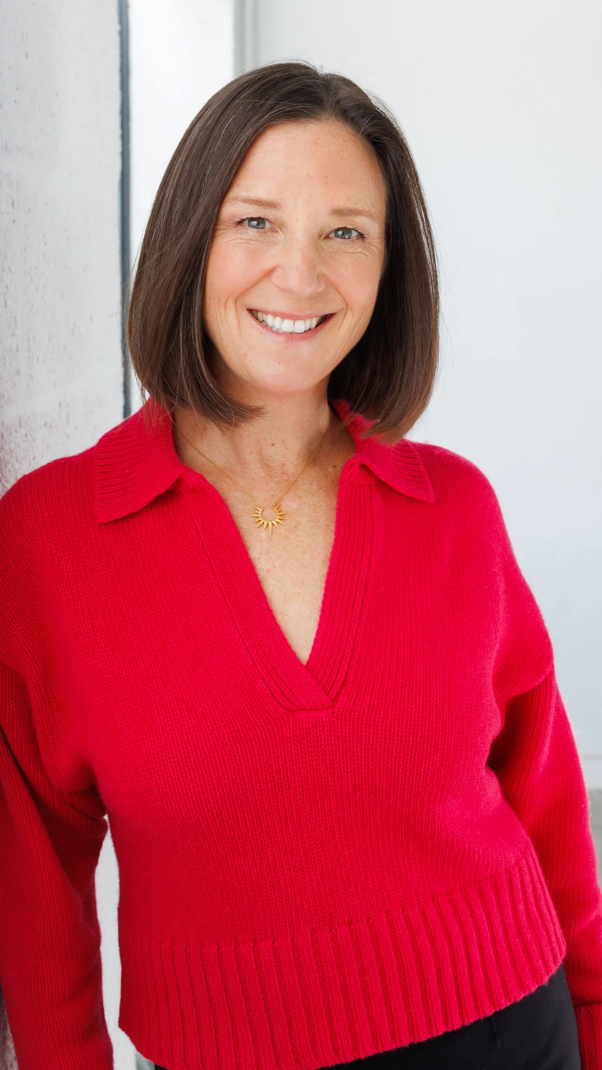 Annie White, LMHC, founder of Clarity Coaching & Counseling, smiling in her Providence office.