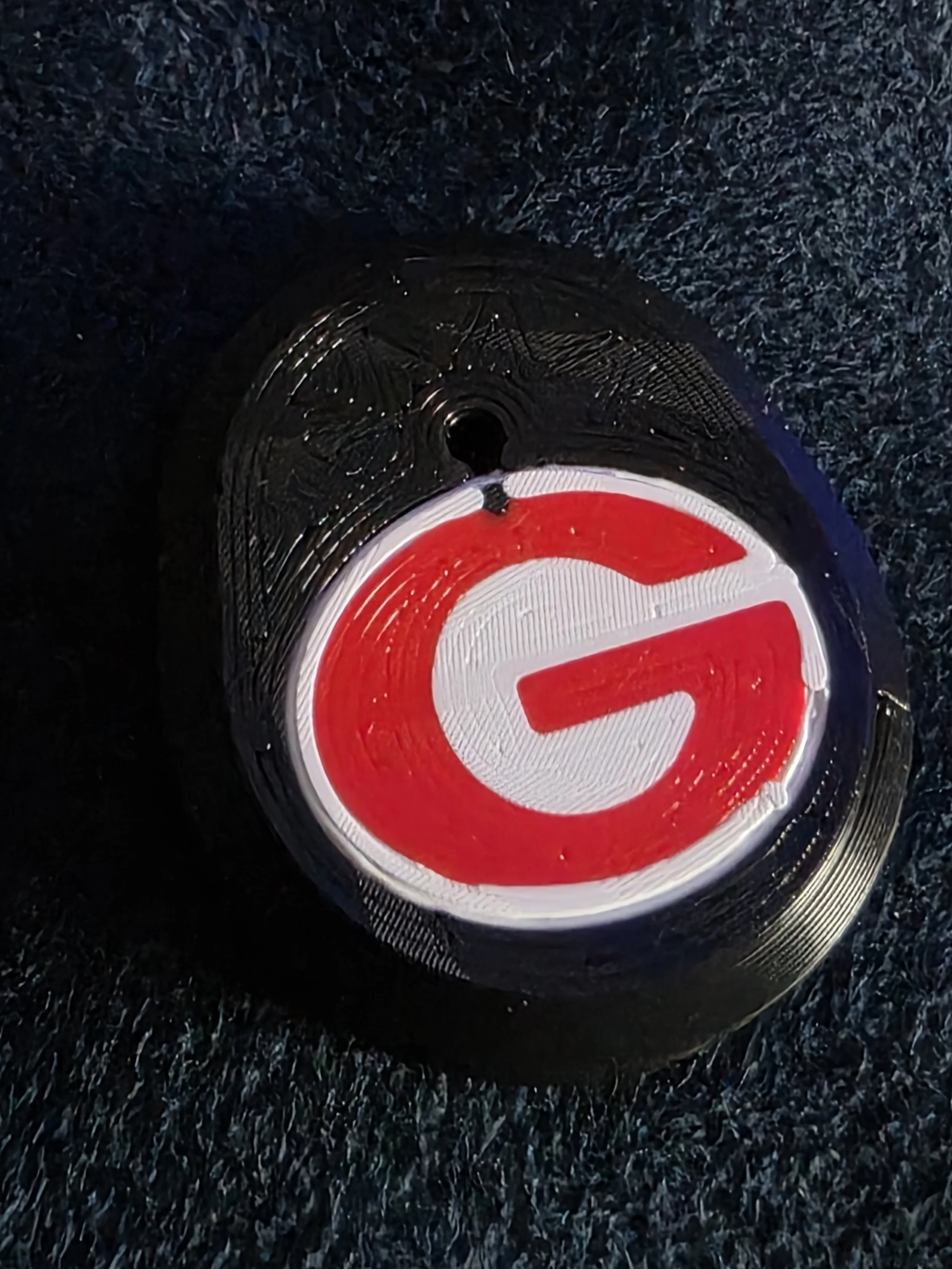 Close-up view of a Target store logo on a circular sign on a black textured surface.