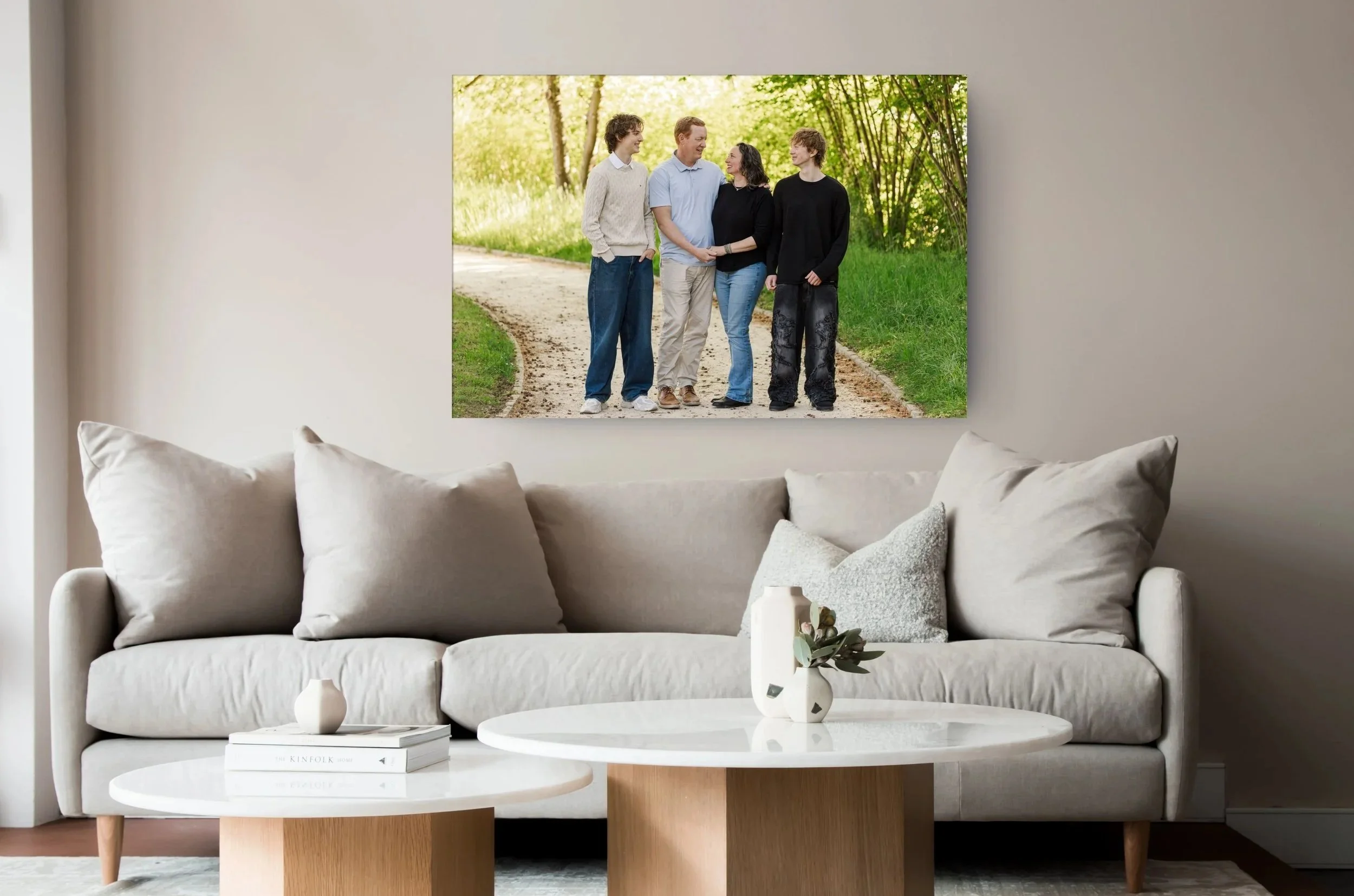 A premium heirloom canvas of a Basel family hung on a plain wall in a modern living room.
