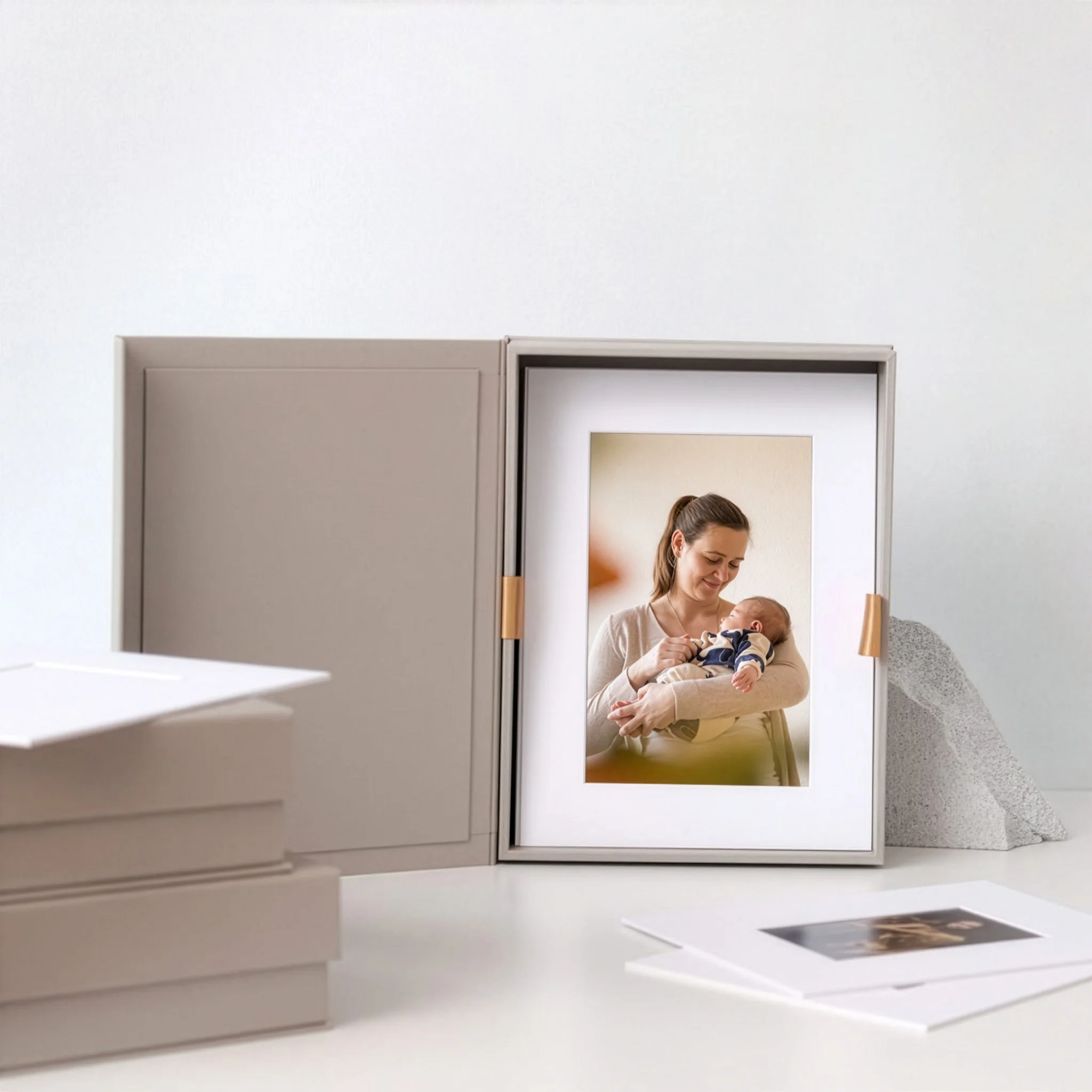 Linen-bound folio box open to reveal a framed family portrait — premium heirloom presentation by The Oak Studio