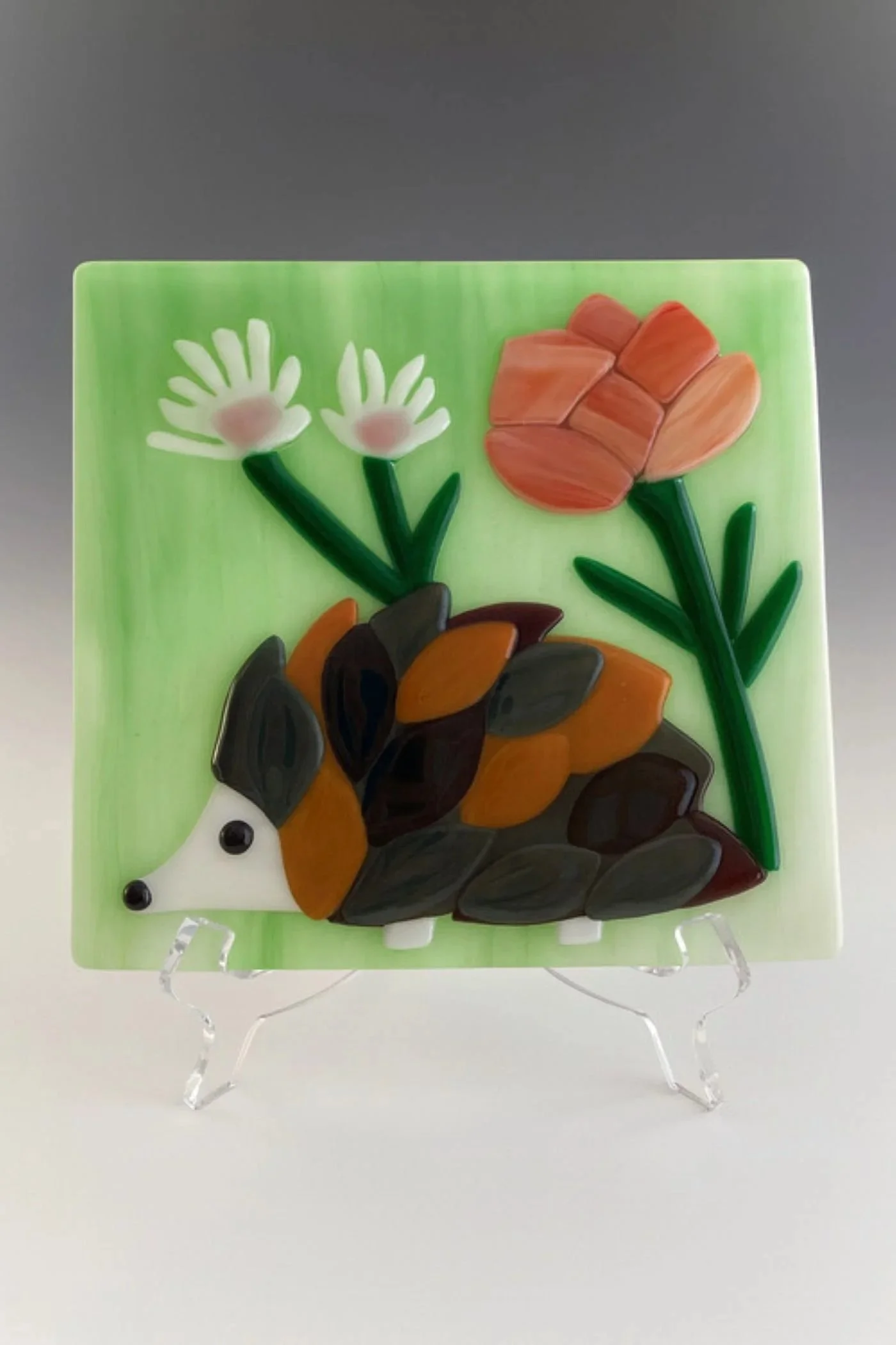 Fused glass tile featuring a hedgehog with flowers. 8 x 8 inch. $155.